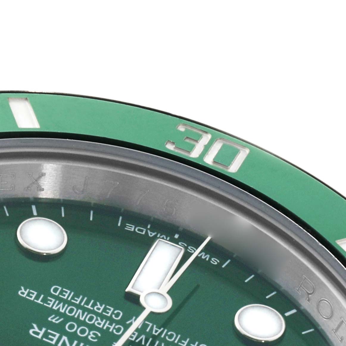 The image shows a close-up angle of the Rolex Submariner 116610LV Men's Stainless Steel Green Dial's green bezel and part of the dial, including the minute markers and luminescent hour markers.