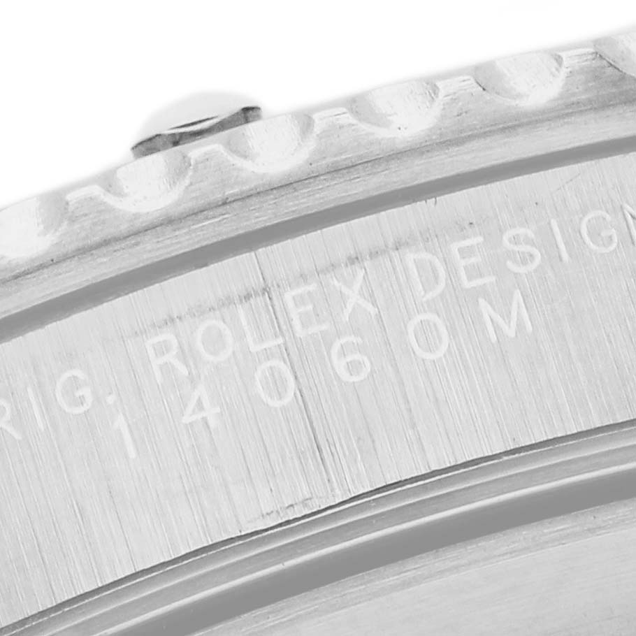 The image shows a close-up of the bezel and engraved side of the Rolex Submariner 14060 Men's Stainless Steel Black Dial watch case.