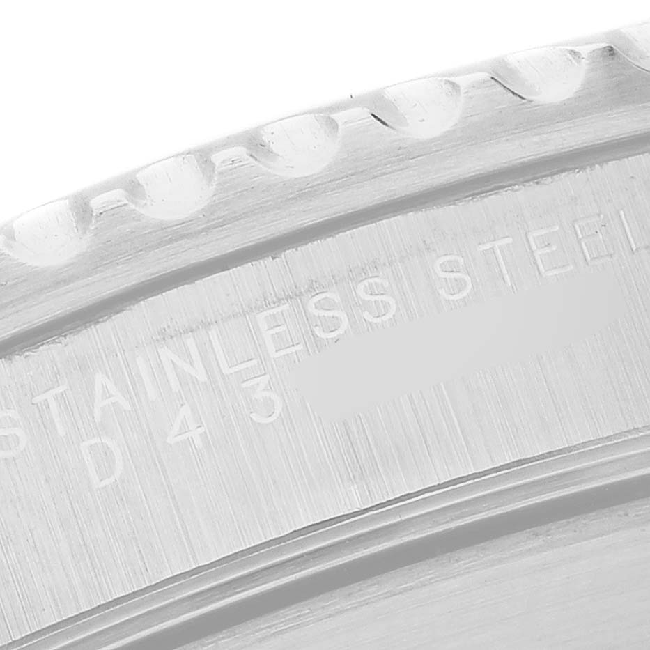 The image shows a close-up of the engraved text on the stainless steel case back of a Rolex Submariner 14060 Men's Stainless Steel Black Dial watch.