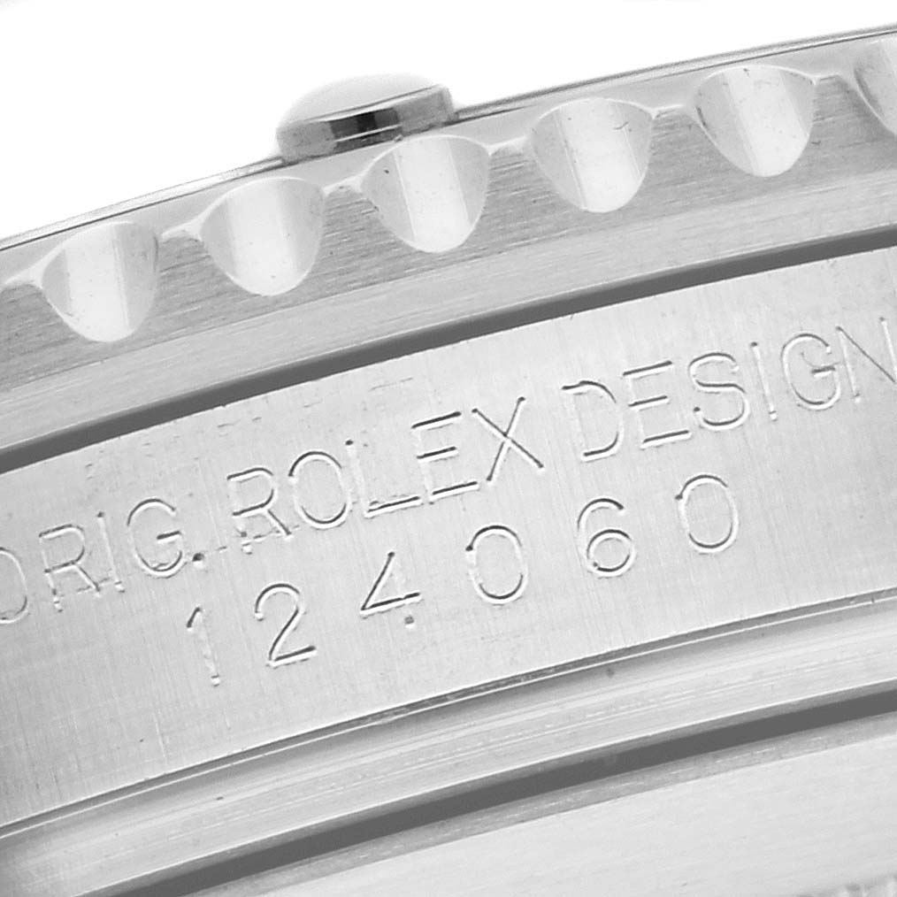 The image shows a close-up of the engraved side of a Rolex Submariner 124060 Men
s Stainless Steel Black Dial 124060 Men
s Stainless Steel Black Dial watch, featuring the model number 124060.