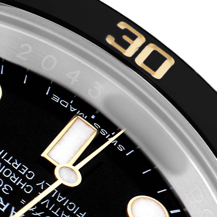 The image shows a close-up of a Rolex Submariner 116613 Men's Steel and Gold (two tone) Black Dial's dial and bezel, highlighting the 30-minute mark and hour markers.