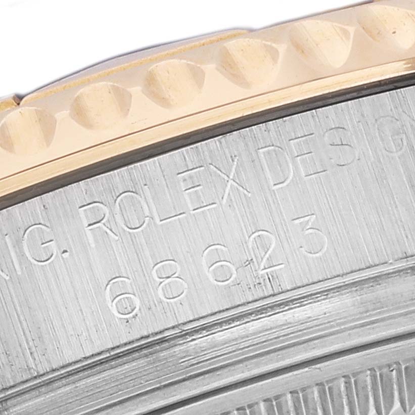 This image shows the engraved side view of a Rolex Yacht-Master 68623 Men's Steel and Gold (two tone) Blue Dial 68623 Men's Steel and Gold (two tone) Blue Dial watch, highlighting the bezel and part of the case.