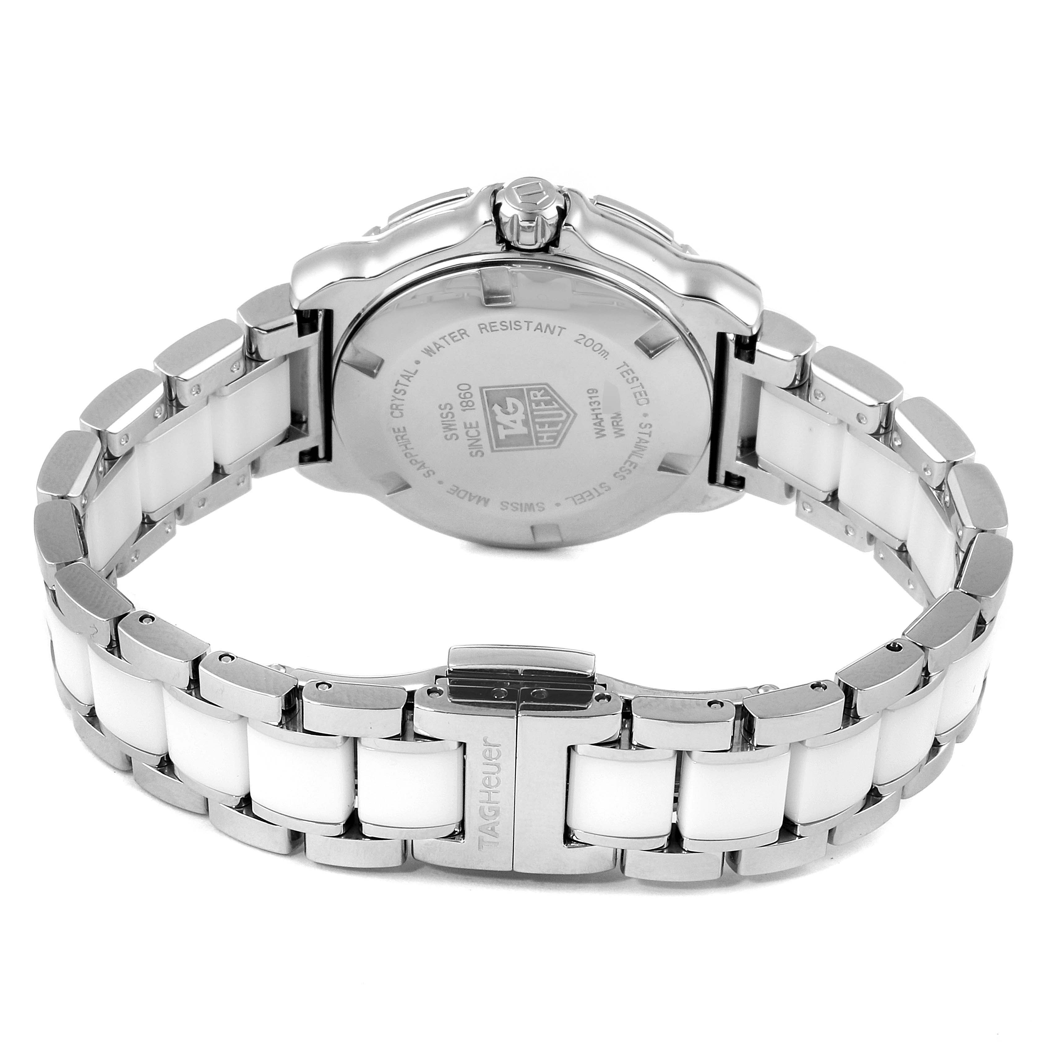 This image shows the back of a Tag Heuer Formula 1 WAH1319.BA0868 Women's Stainless Steel White Dial WAH1319.BA0868 Women's Stainless Steel White Dial watch, highlighting its case back and stainless steel bracelet with white ceramic links.