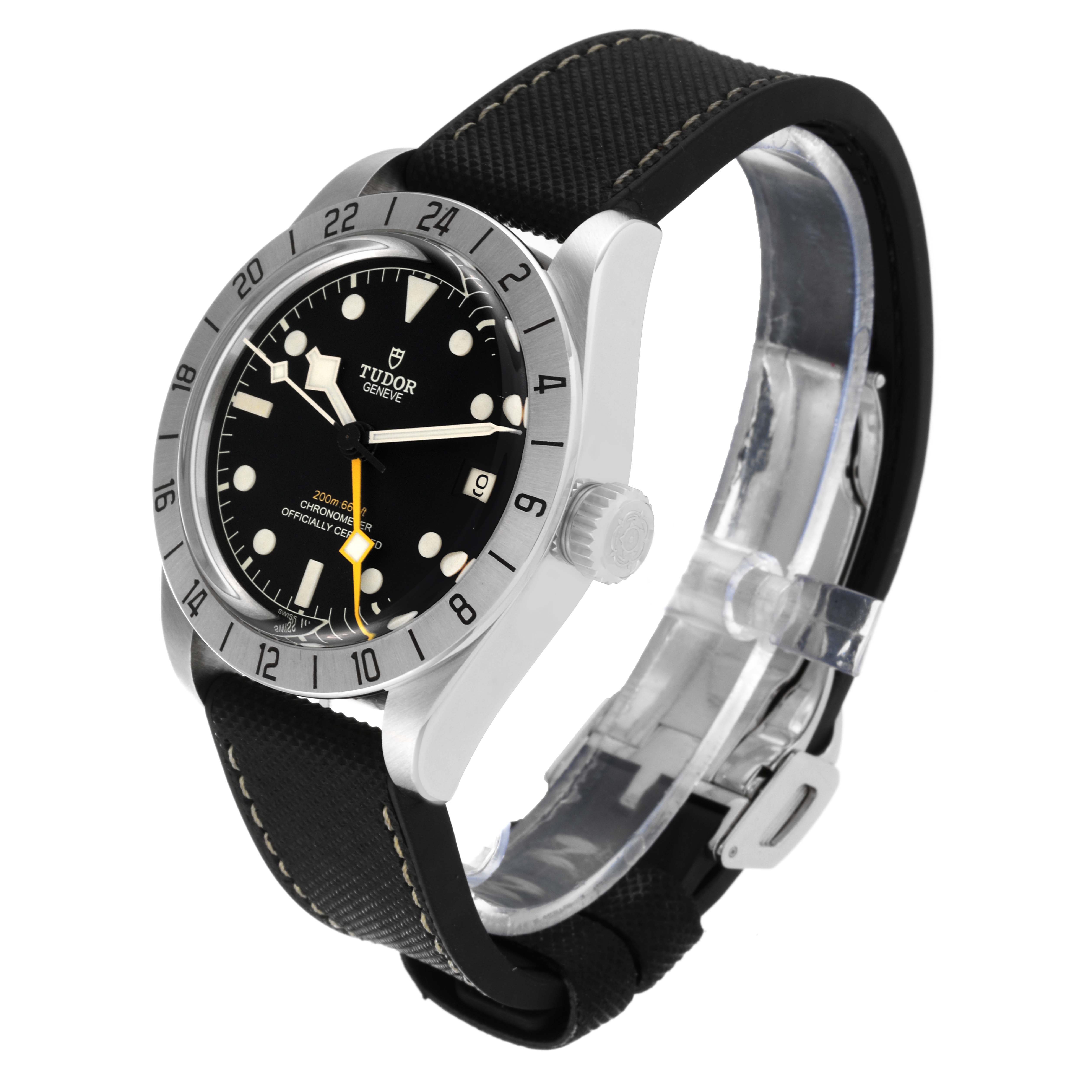 The image shows a Tudor Heritage Black Bay M79470 Men
s Stainless Steel Black Dial M79470 Men
s Stainless Steel Black Dial watch from a 3/4 angle, highlighting its black dial, bezel, crown, and fabric strap.