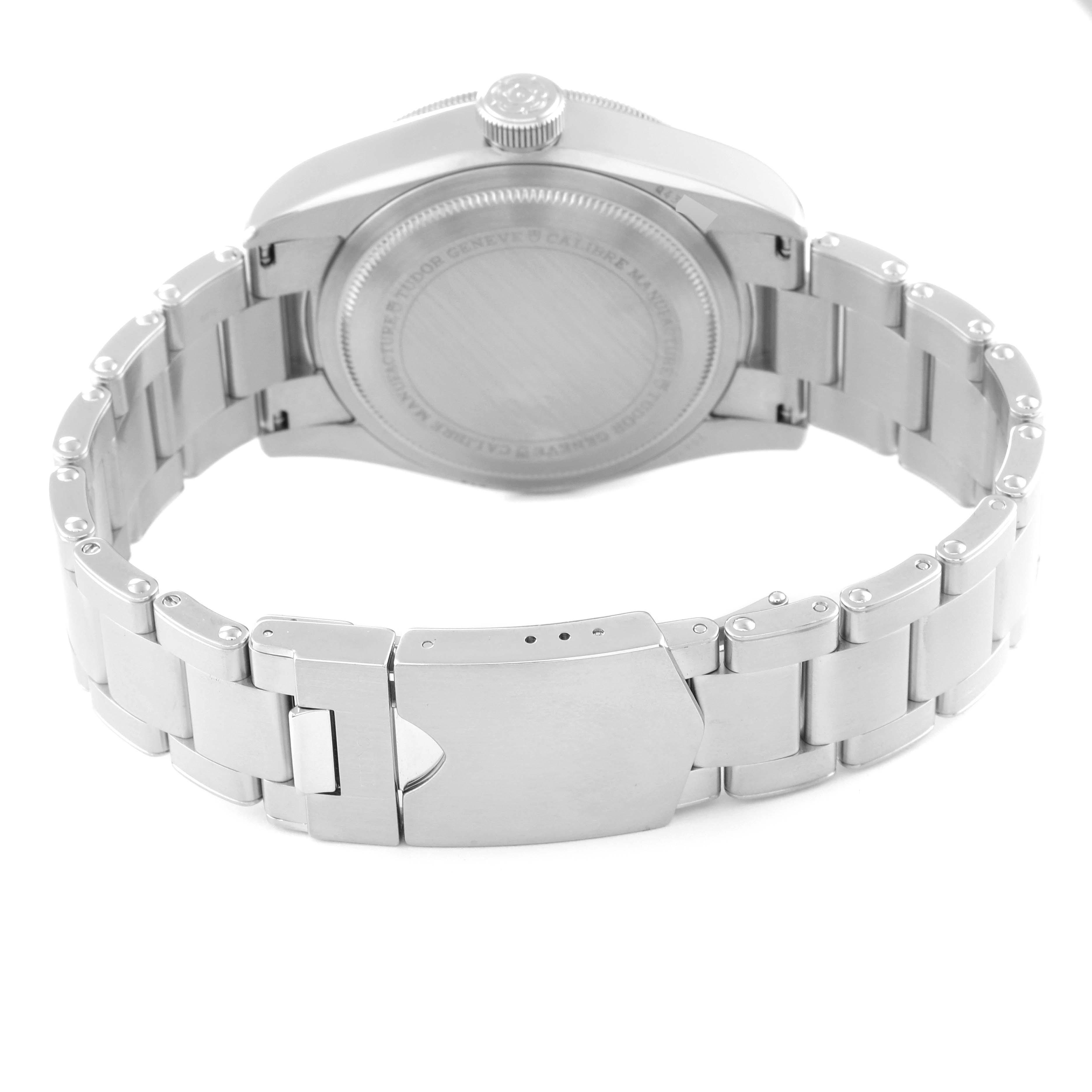 The image shows the back view of a Tudor Heritage Black Bay 79830RB Men
s Stainless Steel Black Dial 79830RB Men
s Stainless Steel Black Dial watch, featuring its caseback, crown, and stainless steel bracelet.