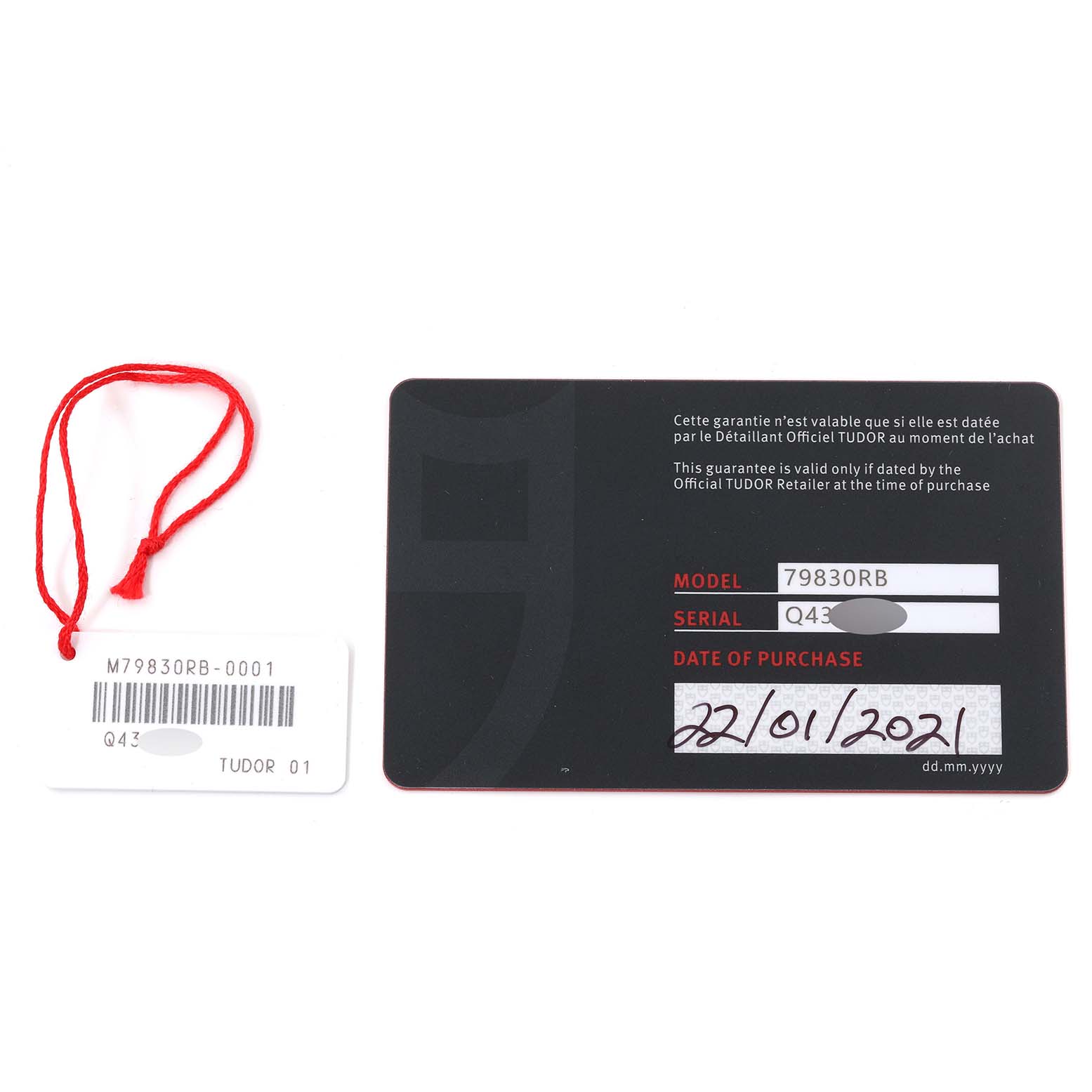 The image shows the guarantee card and a tag for the Tudor Heritage Black Bay 79830RB Men
s Stainless Steel Black Dial 79830RB Men
s Stainless Steel Black Dial model 79830RB.