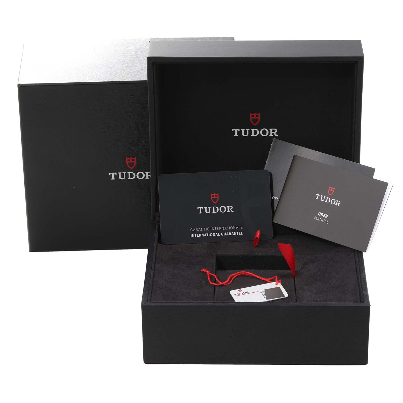 The image shows the packaging, international guarantee card, and user manual for the Tudor Heritage Black Bay 79830RB Men
s Stainless Steel Black Dial 79830RB Men
s Stainless Steel Black Dial watch.