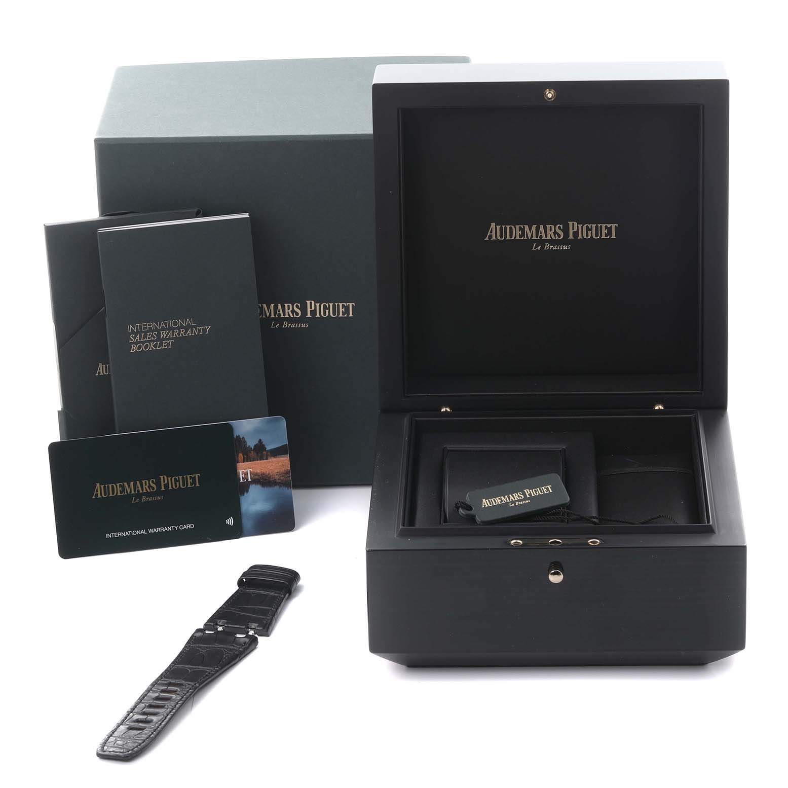 The image shows the packaging and accessories of the Audemars Piguet Royal Oak Offshore 26420RO.OO.A002CA.01 Men's Rose Gold Black Dial 26420RO.OO.A002CA.01 Men's Rose Gold Black Dial, including a box, booklet, cards, and a strap.