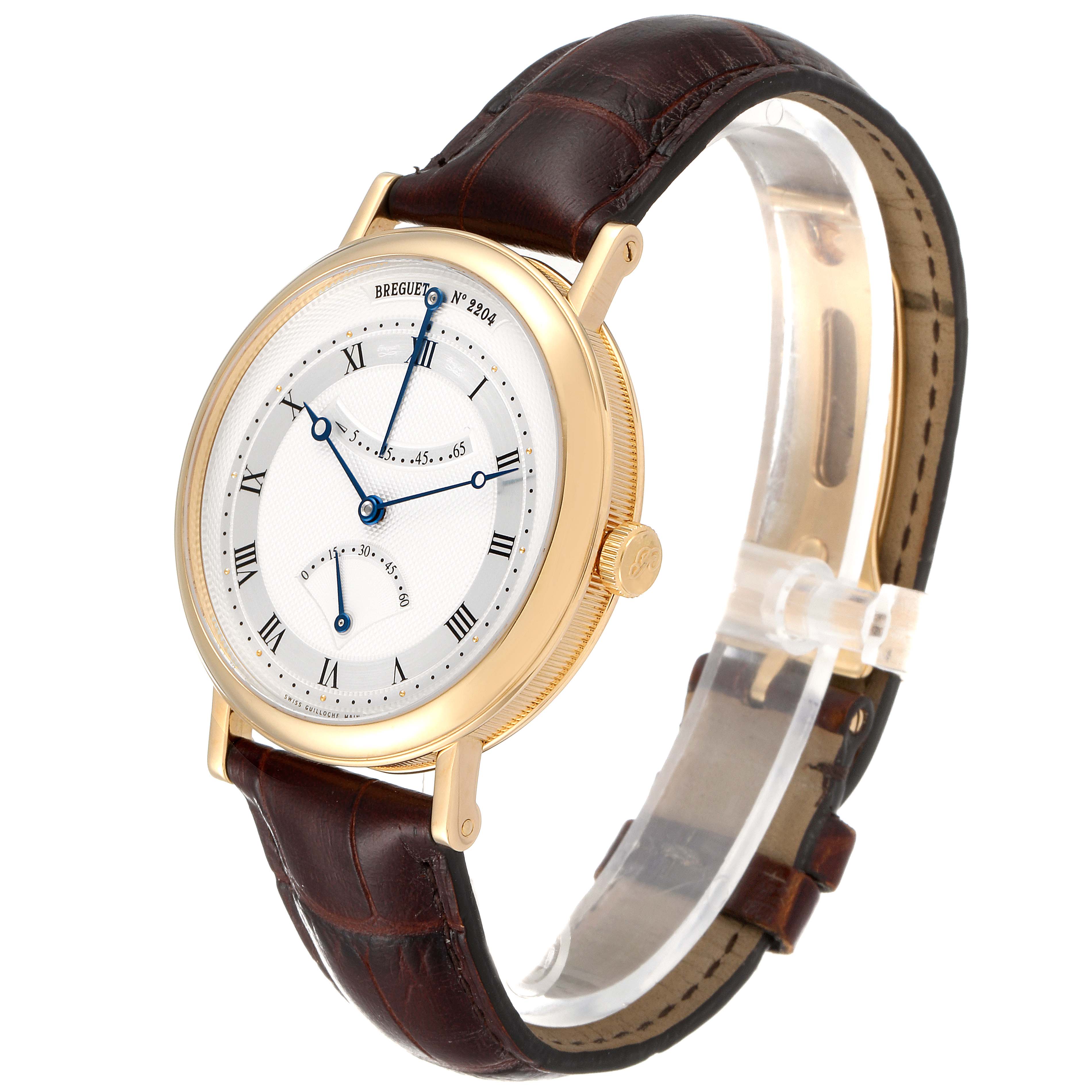 The Breguet Classique 5207BA/12/9V6 Men's Yellow Gold Silver Dial 5207BA/12/9V6 Men's Yellow Gold Silver Dial watch is shown at a slight angle displaying the face, crown, and brown leather strap.