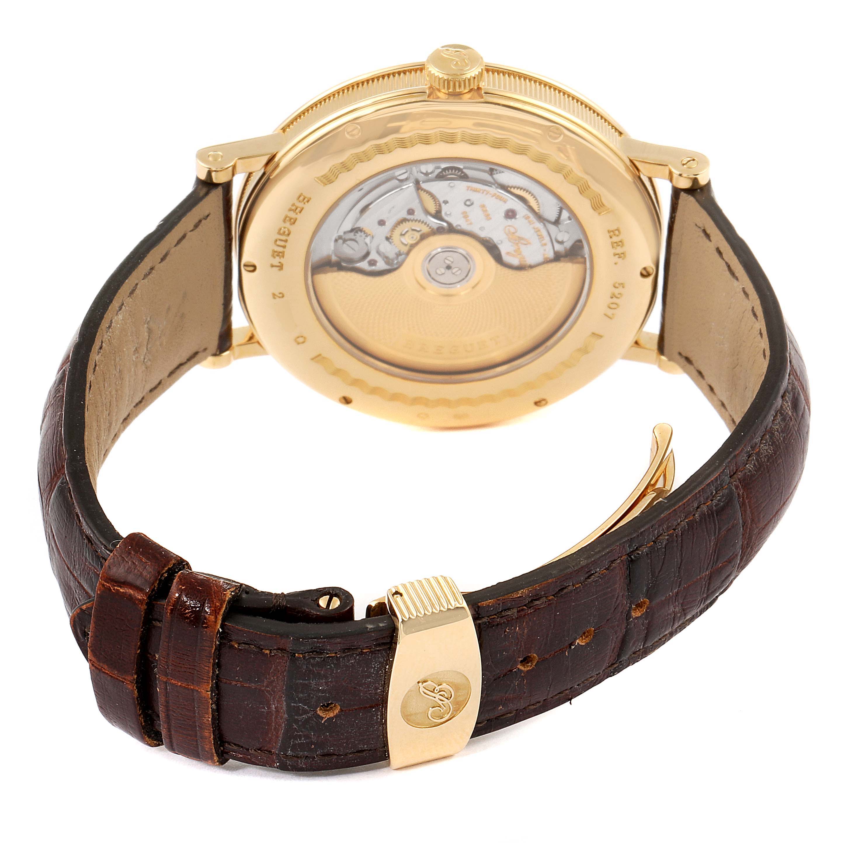 The image shows the rear view of the Breguet Classique 5207BA/12/9V6 Men's Yellow Gold Silver Dial 5207BA/12/9V6 Men's Yellow Gold Silver Dial watch, featuring its movement and leather strap.