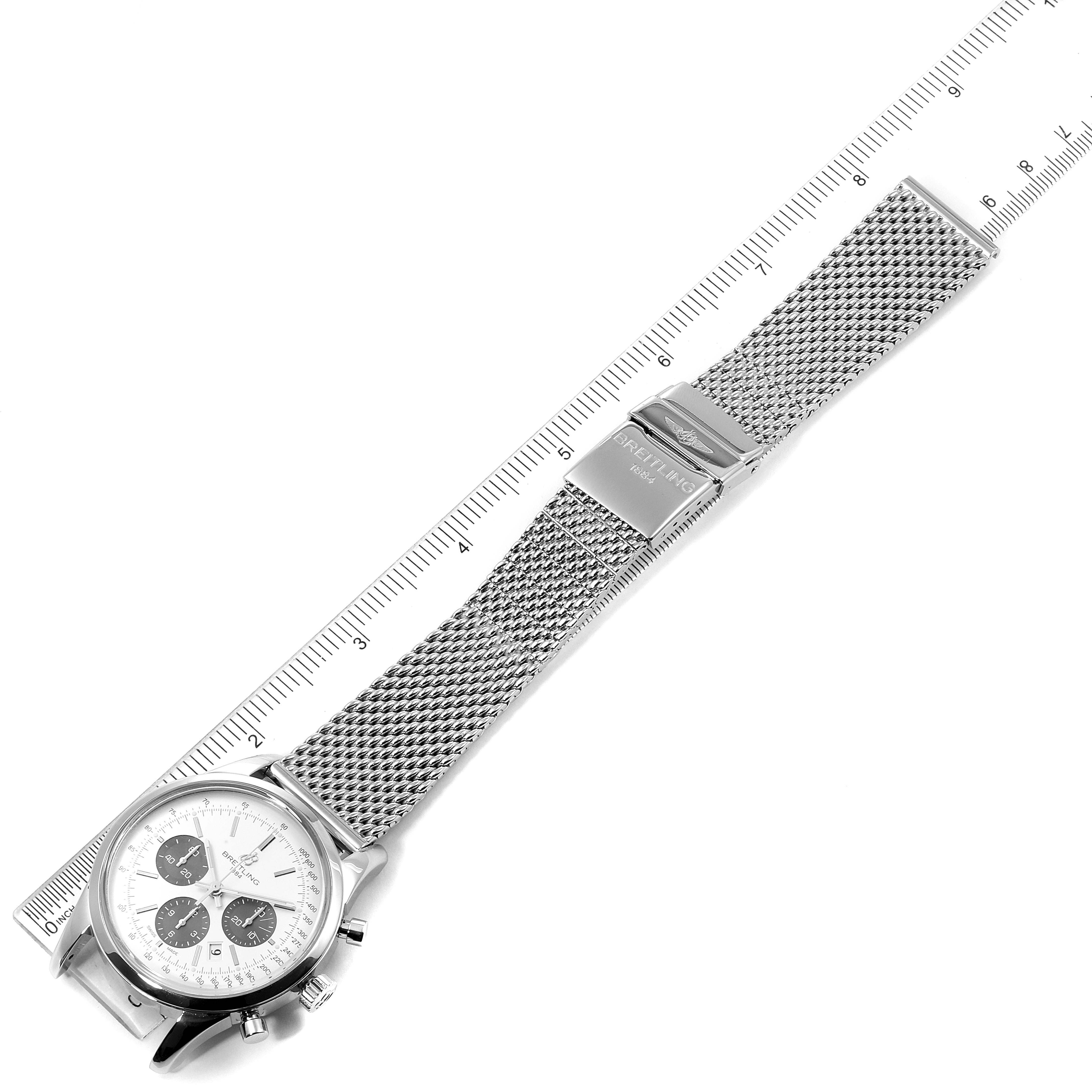 This image shows a Breitling Transocean AB015212/G724 Men
s Stainless Steel Silver Dial AB015212/G724 Men
s Stainless Steel Silver Dial watch laid flat, displaying the dial, mesh strap, and clasp, with a ruler for scale.