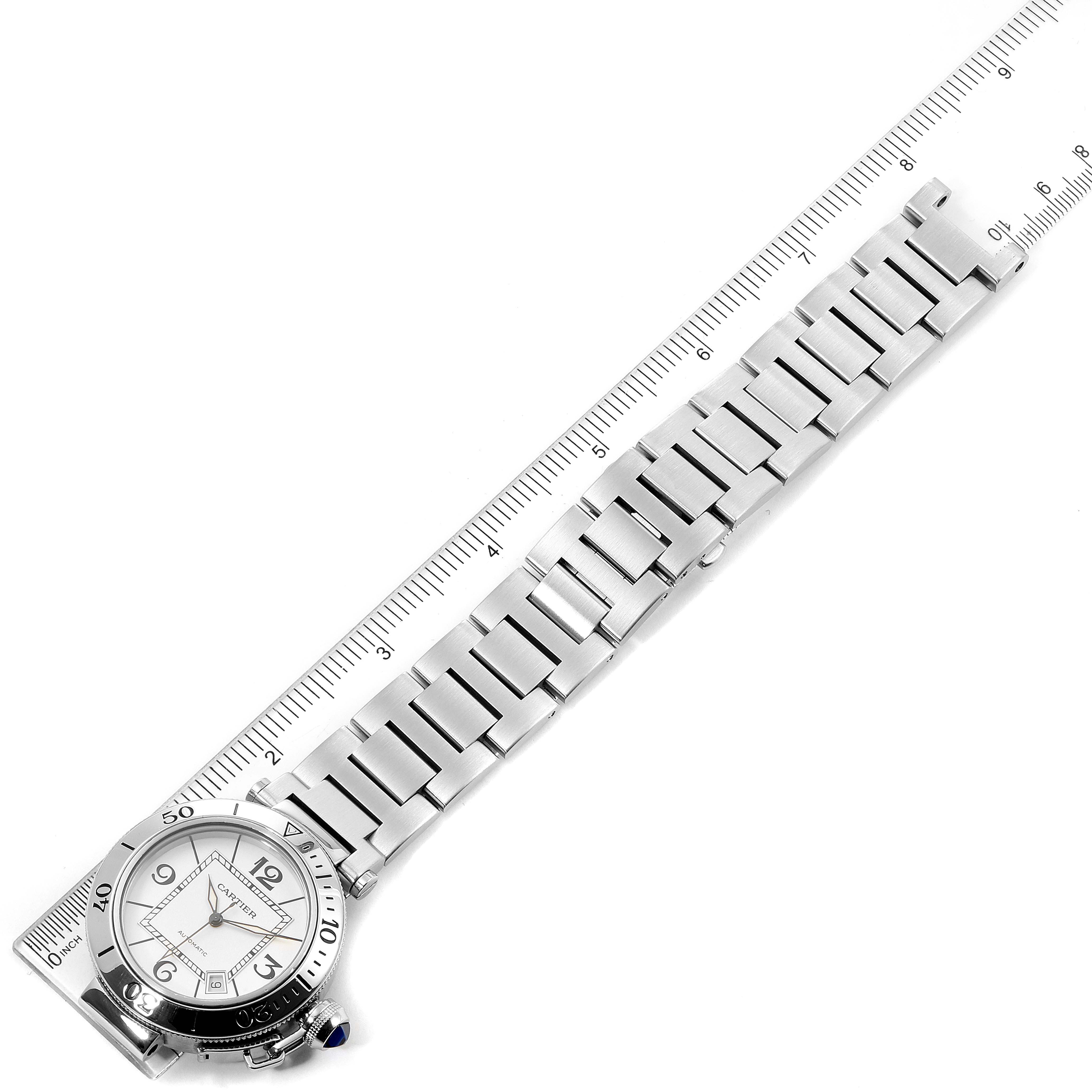 This image shows a top view of the Cartier Pasha W31080M7 Men
s Stainless Steel Silver Dial W31080M7 Men
s Stainless Steel Silver Dial watch, displaying the dial and stainless steel bracelet alongside a ruler for scale.