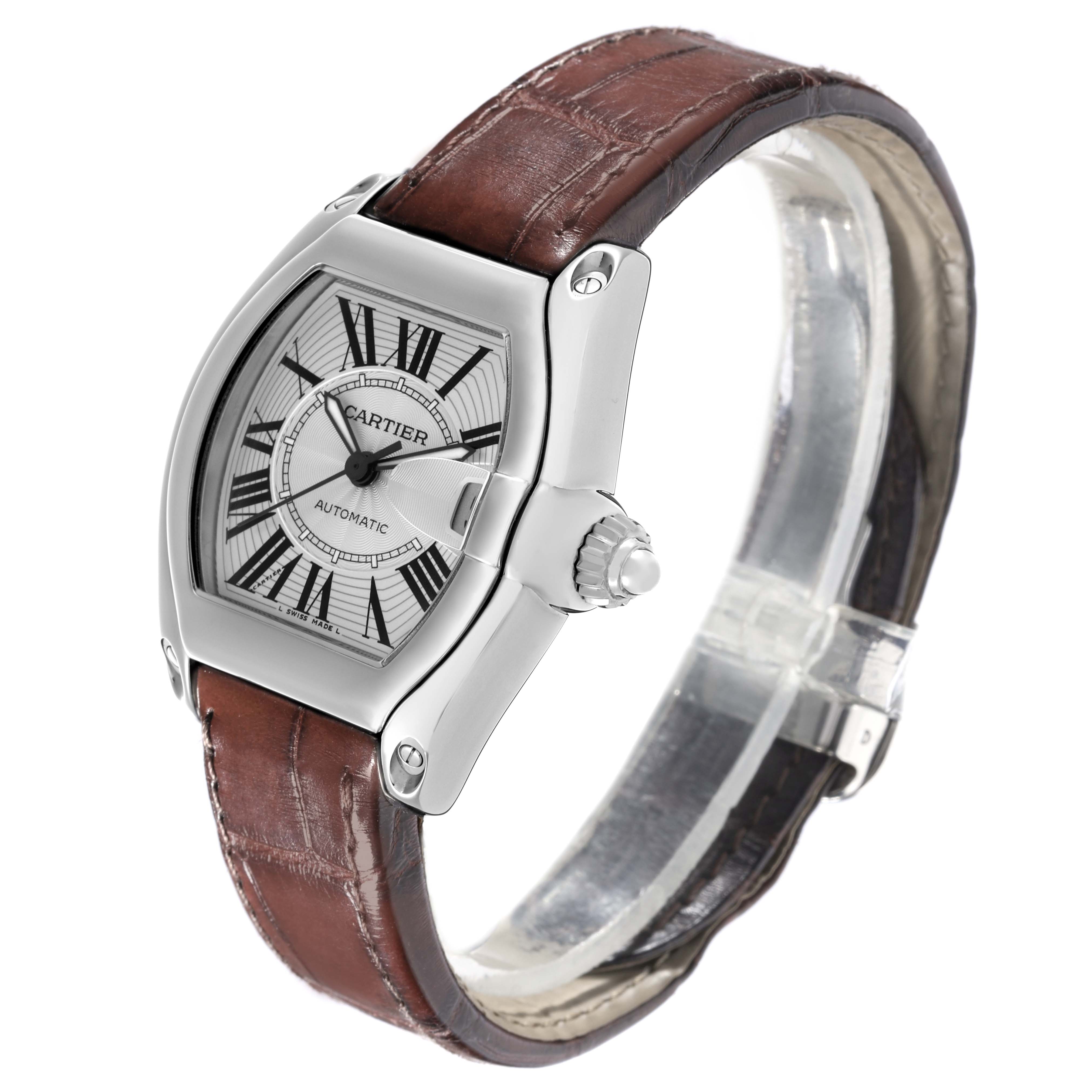 The Cartier Roadster W62025V3 Men's Stainless Steel Silver Dial W62025V3 Men's Stainless Steel Silver Dial watch is shown at an angled side view, highlighting its face, case, crown, and leather strap.