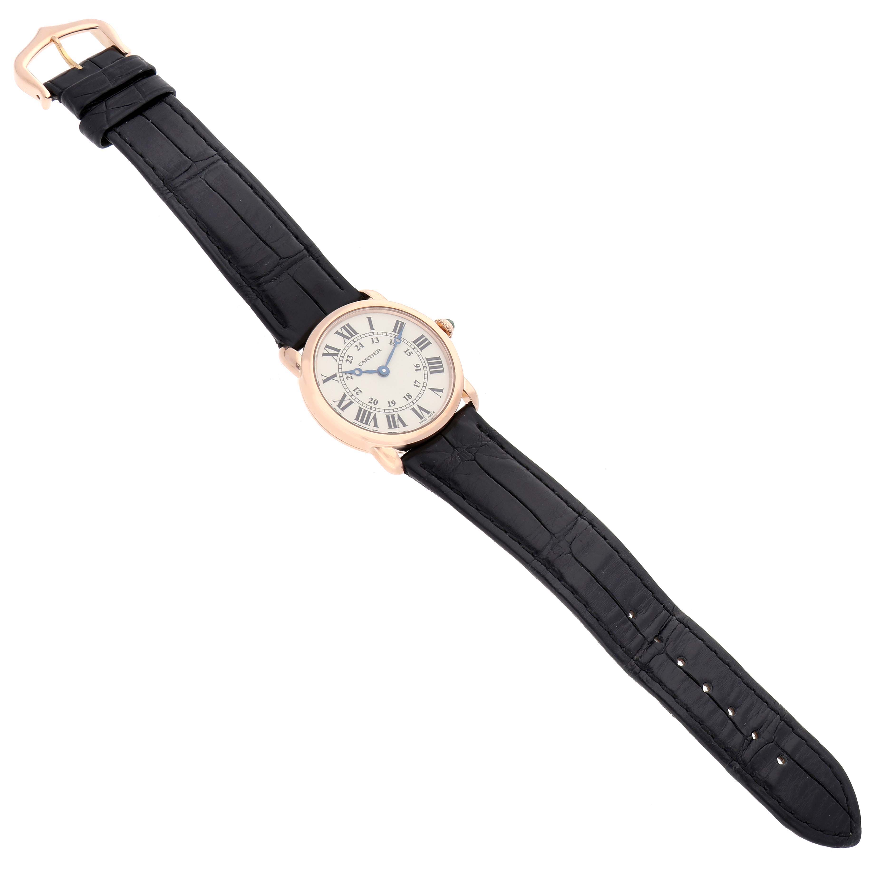 The Cartier Ronde W6800151 Women's Rose Gold Silver Dial W6800151 Women's Rose Gold Silver Dial watch is shown from a top-down angle, displaying the face, case, and entire black leather strap.