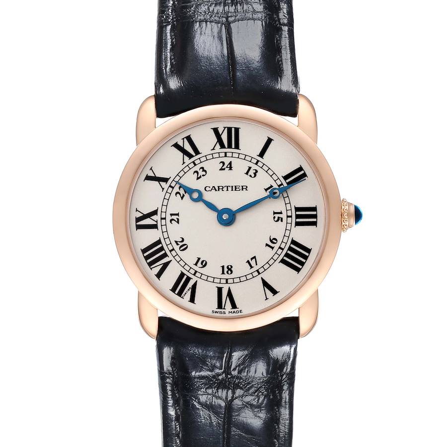 The Cartier Ronde watch is shown from the front, featuring its Roman numeral dial, blue hands, gold case, and black leather strap.