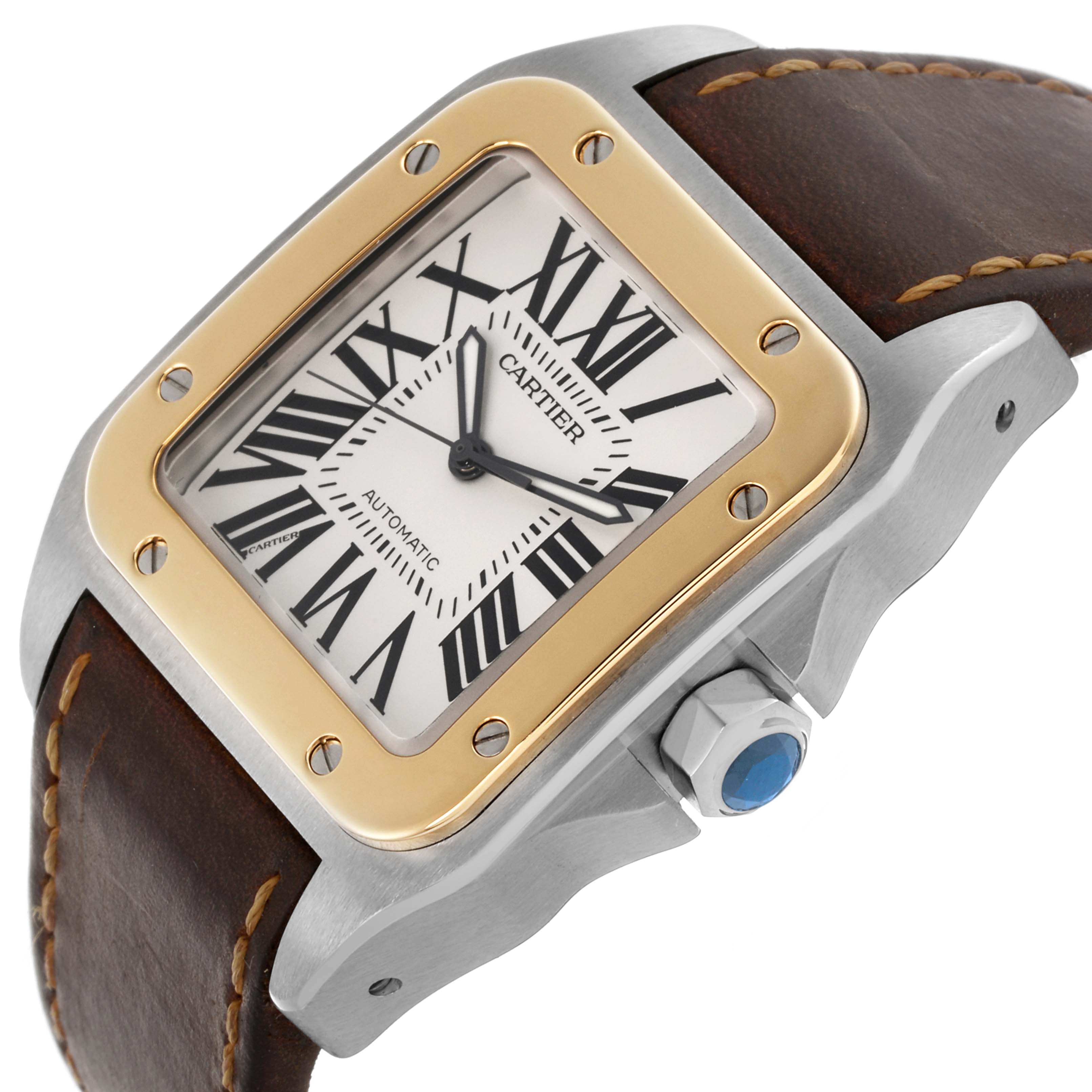 The Cartier Santos W20072X7 Men's Steel and Gold (two tone) Silver Dial W20072X7 Men's Steel and Gold (two tone) Silver Dial watch is shown from an angled side view, highlighting its dial, bezel, crown, and leather strap.