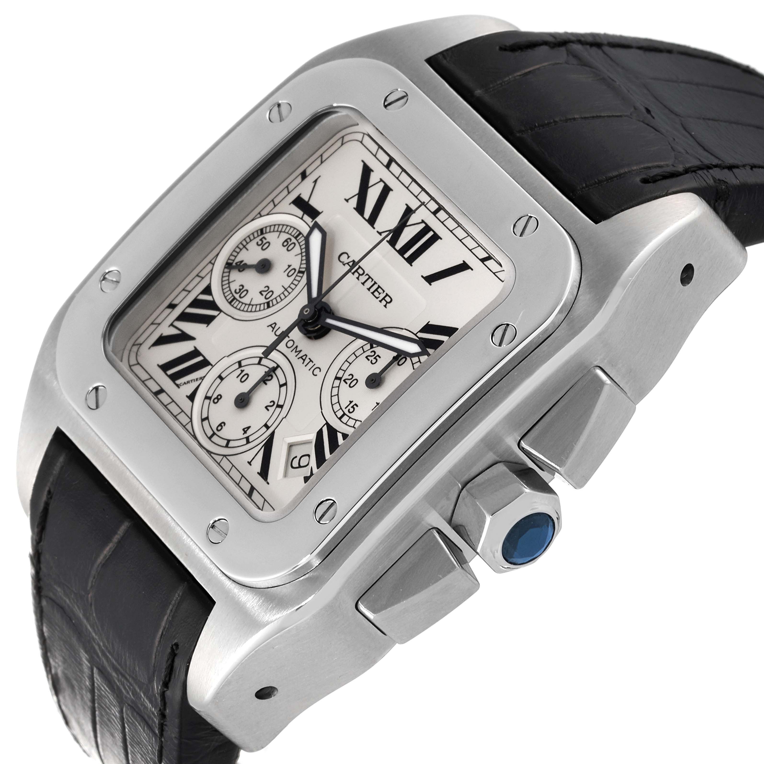 The Cartier Santos W20090X8 Men's Stainless Steel Silver Dial W20090X8 Men's Stainless Steel Silver Dial watch is shown at an angle highlighting the dial, bezel, crown with a blue gem, and leather strap.
