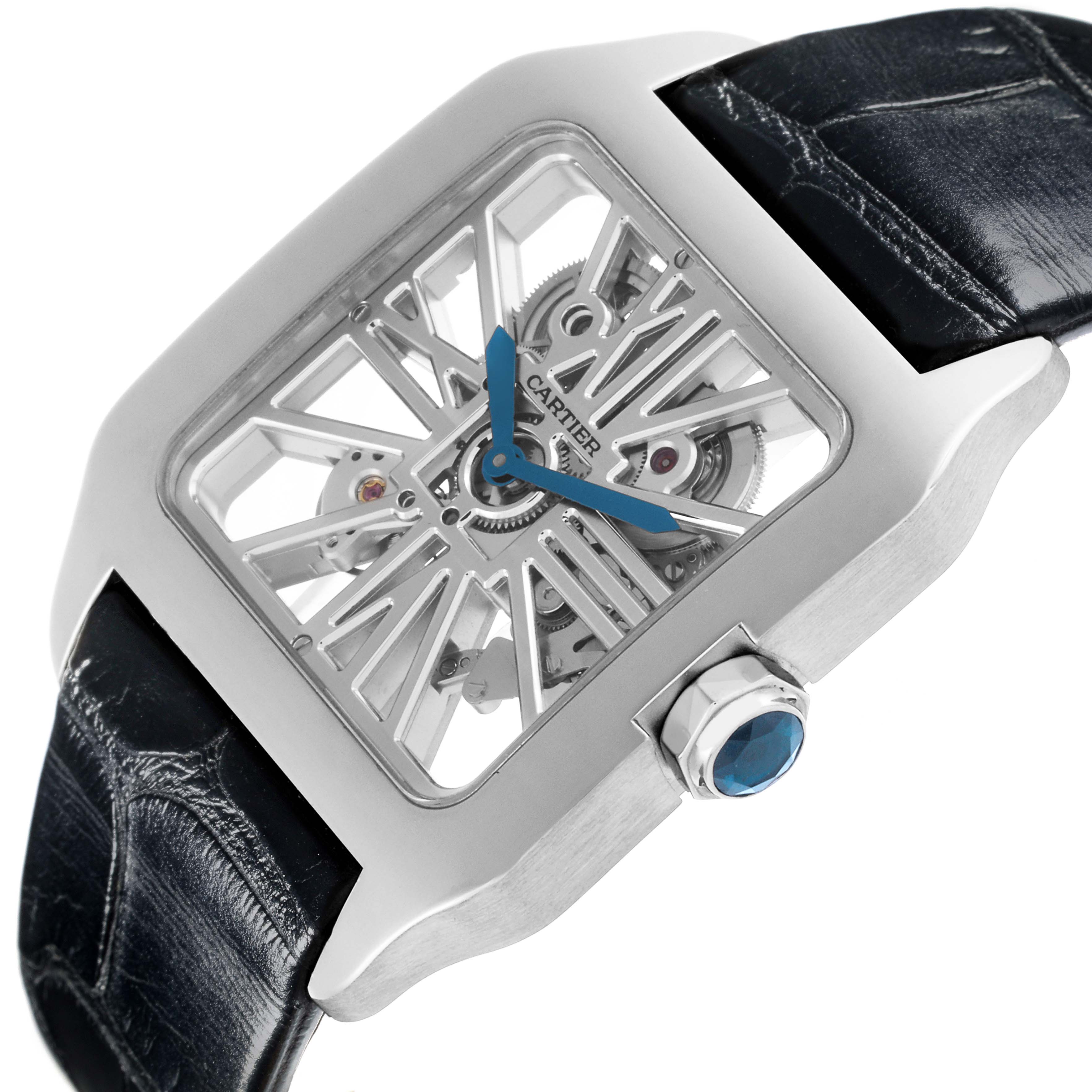 The Cartier Santos Dumont W2020033 Men's White Gold Transparent Dial W2020033 Men's White Gold Transparent Dial watch is shown at an angled close-up, highlighting its skeleton dial, blue hands, and crown with a blue cabochon.