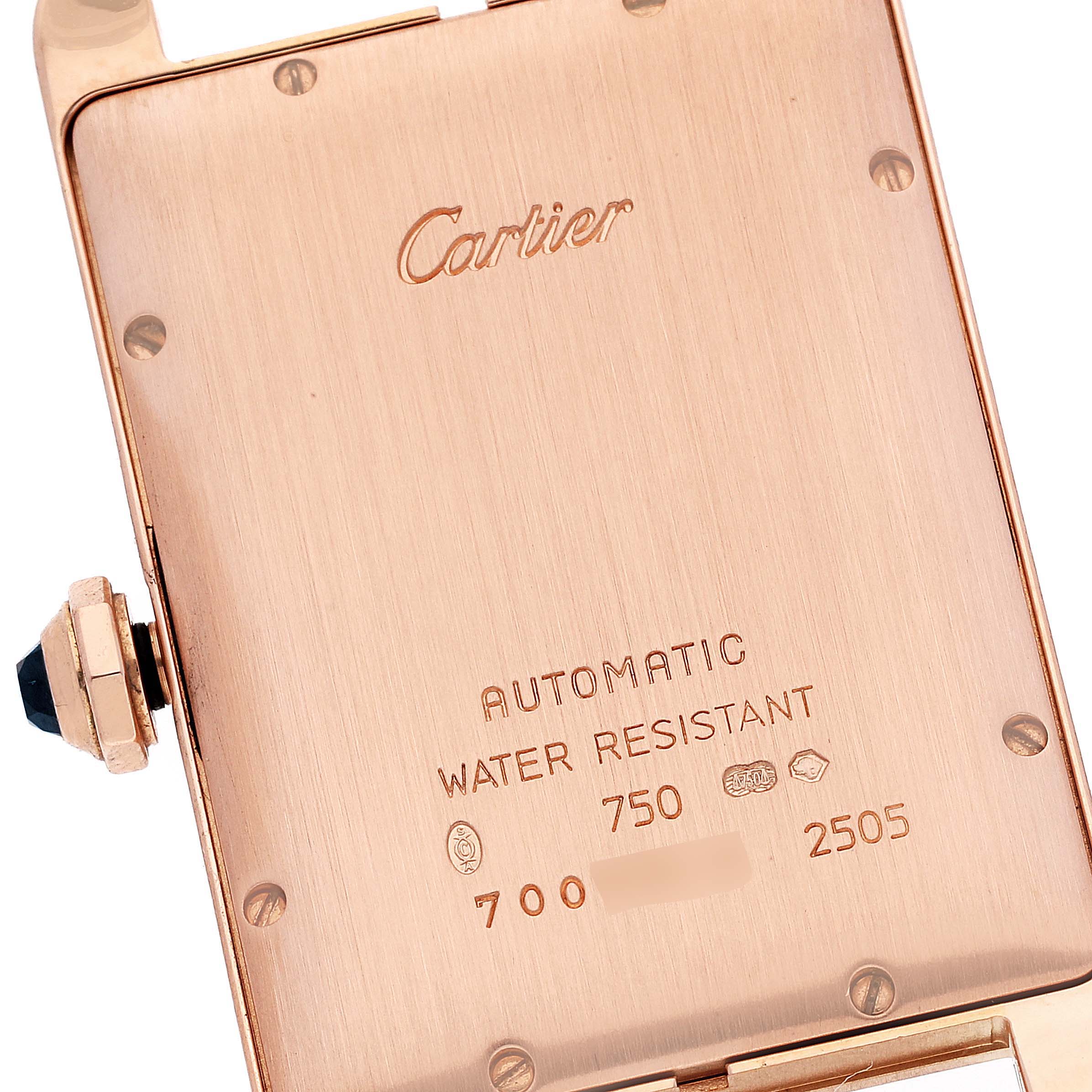 The image shows the back case of a Cartier Tank Americaine W2609156 Men's Rose Gold Silver Dial W2609156 Men's Rose Gold Silver Dial watch, highlighting its inscriptions and crown.