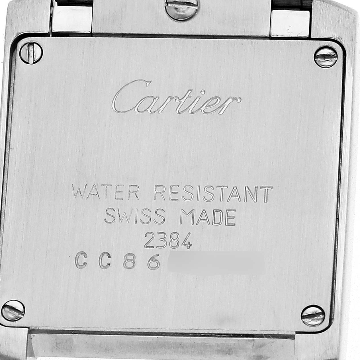 The image shows the back case of a Cartier Tank Française watch, displaying engravings and screws.