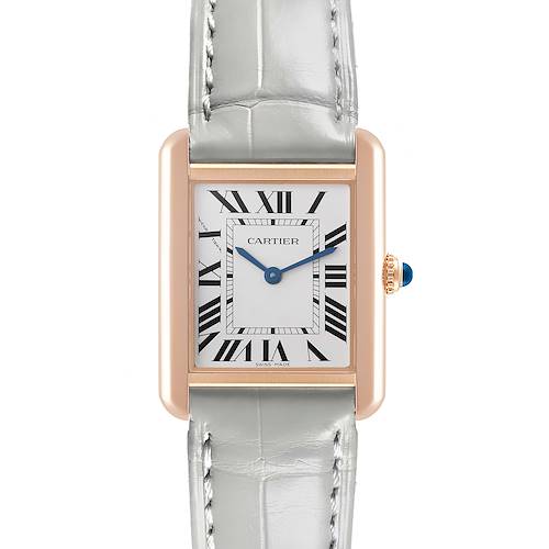 The Cartier Tank Solo watch is shown from a top-down angle, highlighting the face, roman numerals, and light-colored strap.