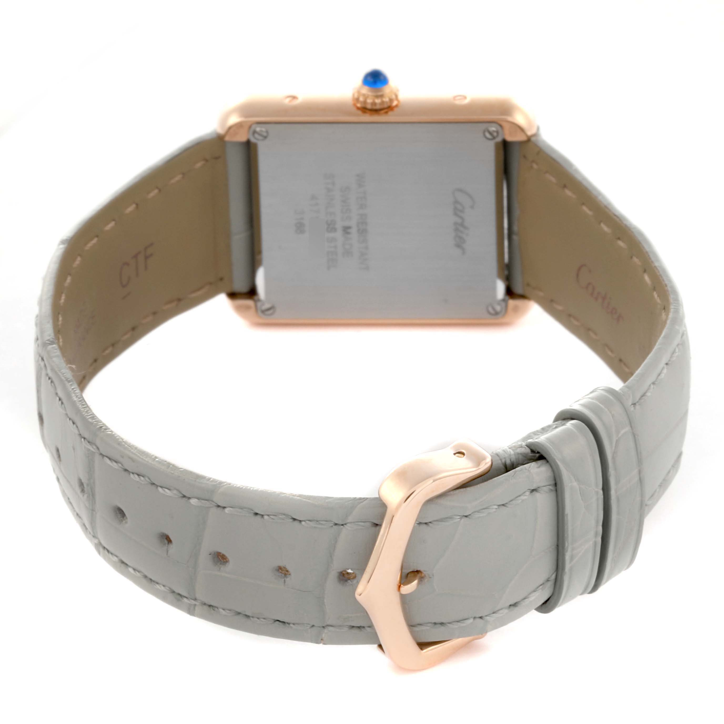 The Cartier Tank Solo W5200024 Women's Steel and Gold (two tone) Silver Dial W5200024 Women's Steel and Gold (two tone) Silver Dial watch is shown from the back, highlighting its case, crown, and grey strap with a buckle.