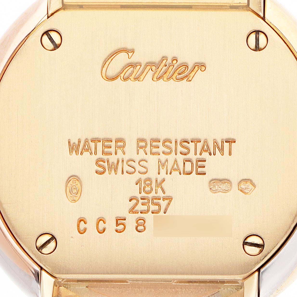 The image shows the back of a Cartier Trinity WG200258 Women's Yellow Gold White Dial watch, featuring engraved specifications like "18K" and "Swiss Made."