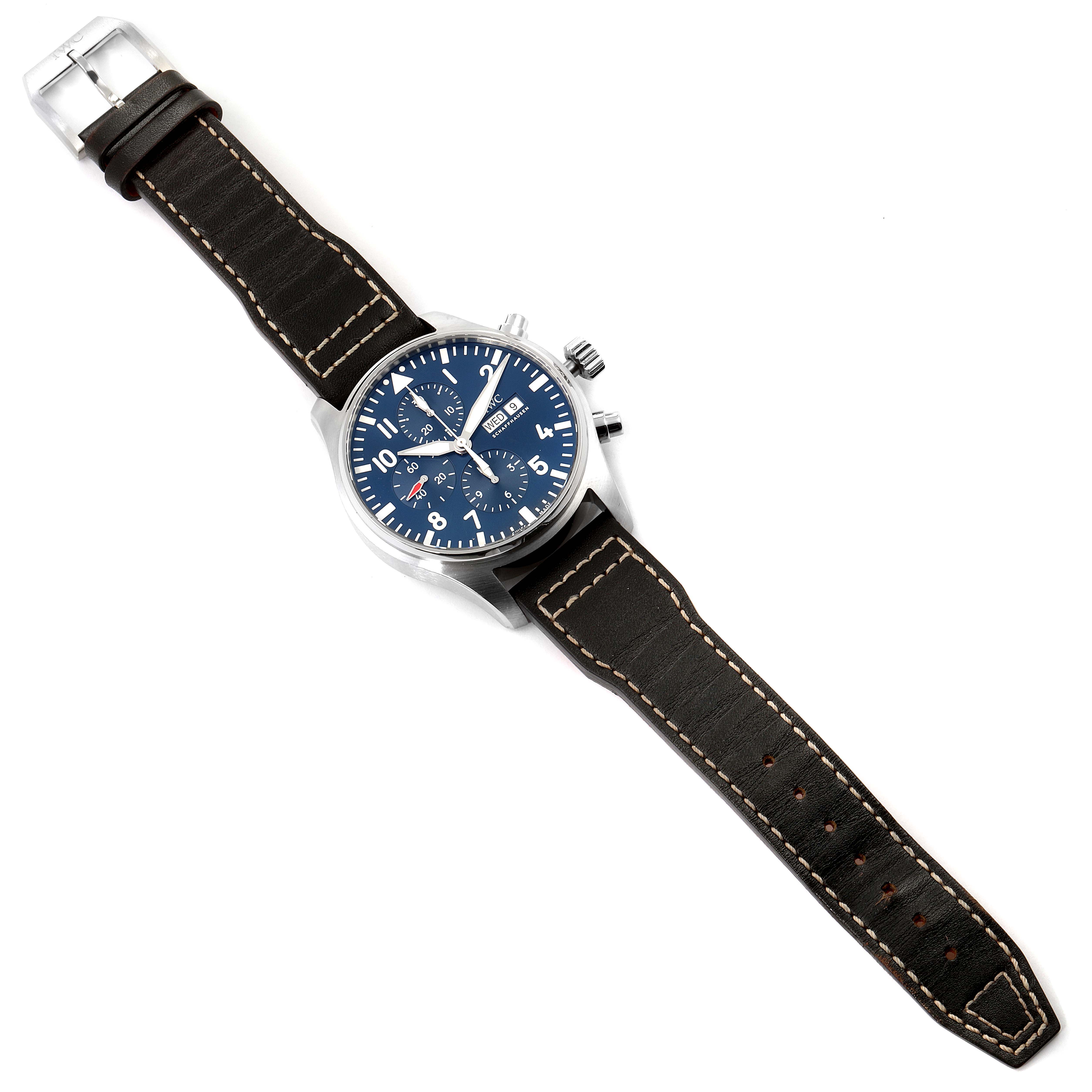 The IWC Pilot IW377714 Men's Stainless Steel Blue Dial IW377714 Men's Stainless Steel Blue Dial model watch is shown at an angled top view, displaying the blue dial, leather strap, and metal clasps.