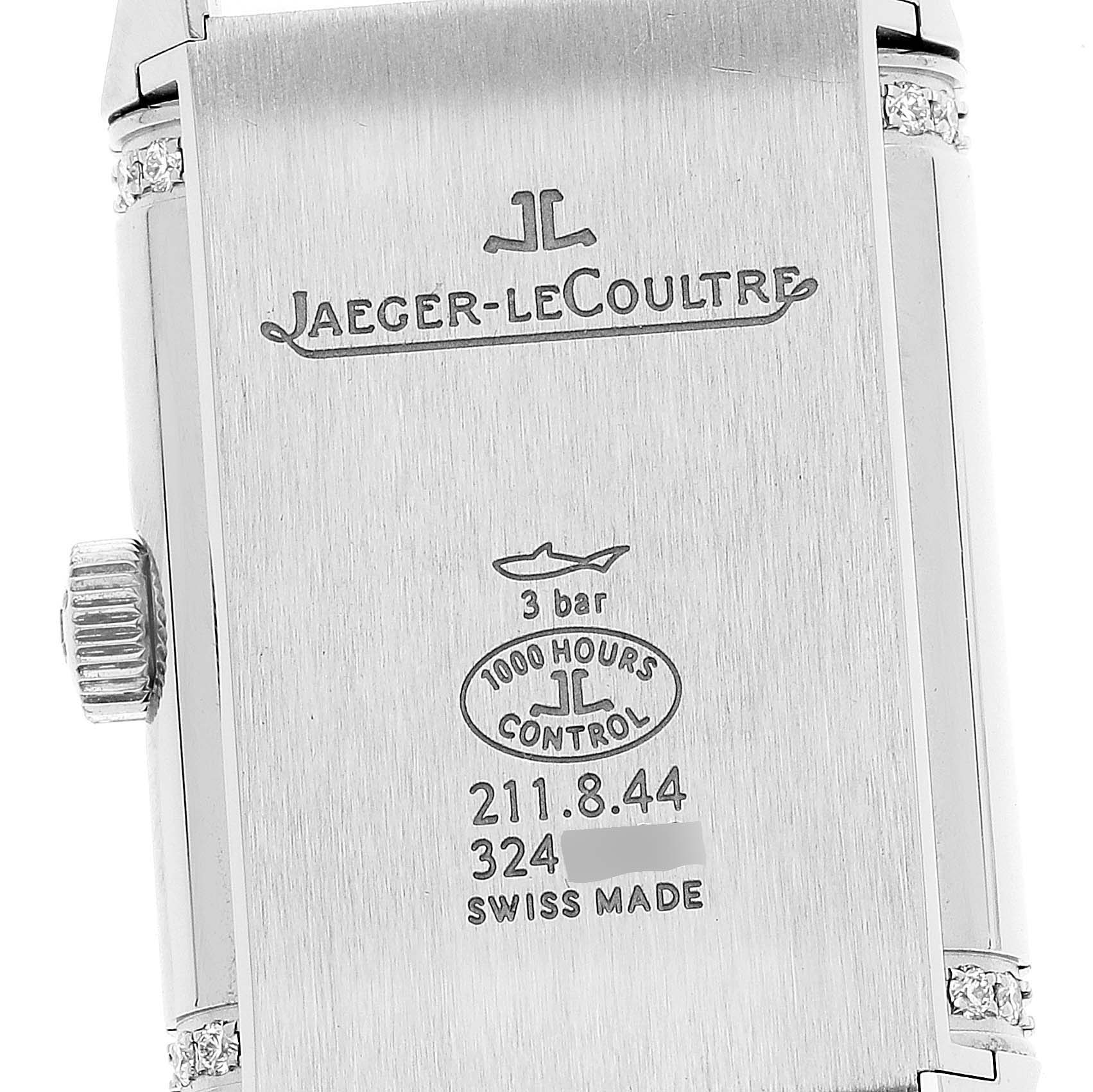 The image shows the back view of a Jaeger-LeCoultre Reverso watch case with engravings and markings.