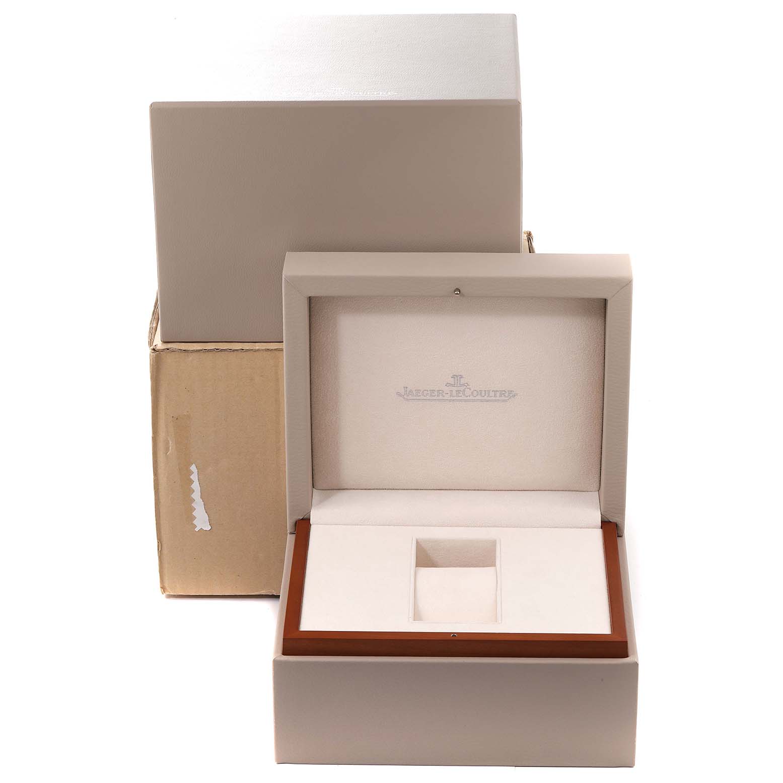 The image shows an open luxury watch box for a Jaeger-LeCoultre Reverso model, with another box in the background.
