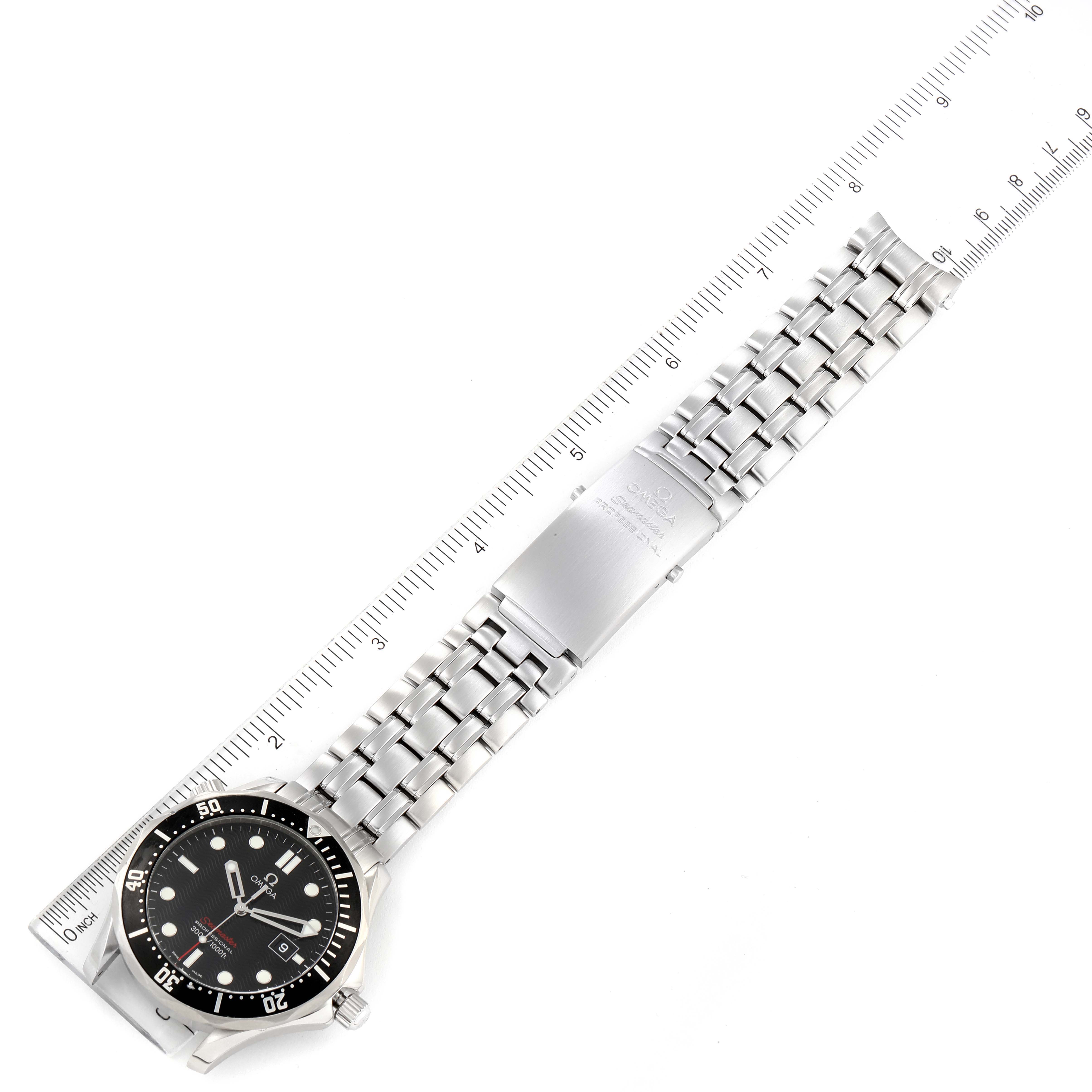 The image shows the Omega Seamaster 212.30.41.61.01.001 Men's Stainless Steel Black Dial 212.30.41.61.01.001 Men's Stainless Steel Black Dial watch laid flat with its face, dial, and metal bracelet band fully visible next to a ruler.