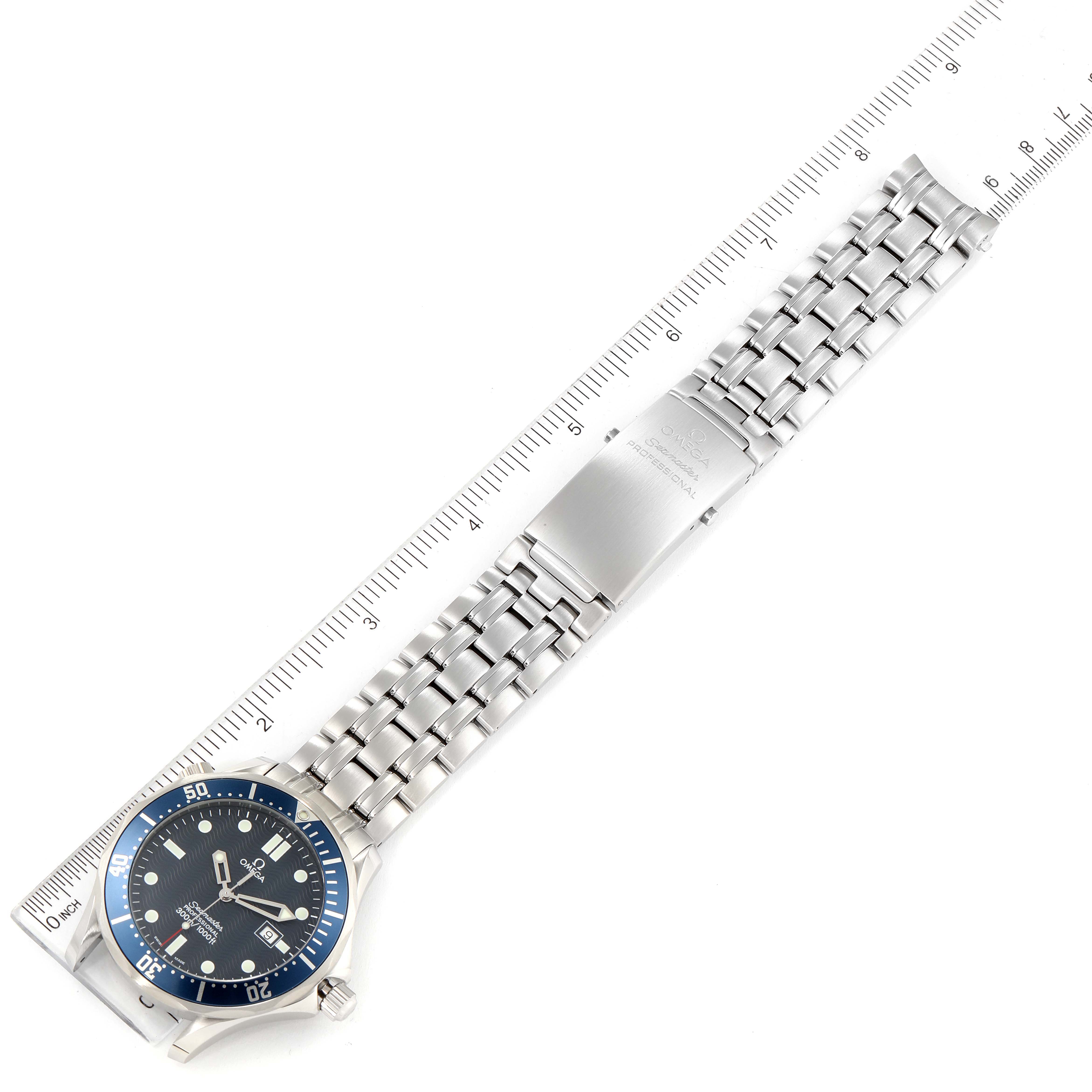 The image shows an Omega Seamaster 2541.80.00 Men's Stainless Steel Blue Dial 2541.80.00 Men's Stainless Steel Blue Dial watch lying flat with its dial, bezel, bracelet, and clasp visible, next to a measuring ruler.