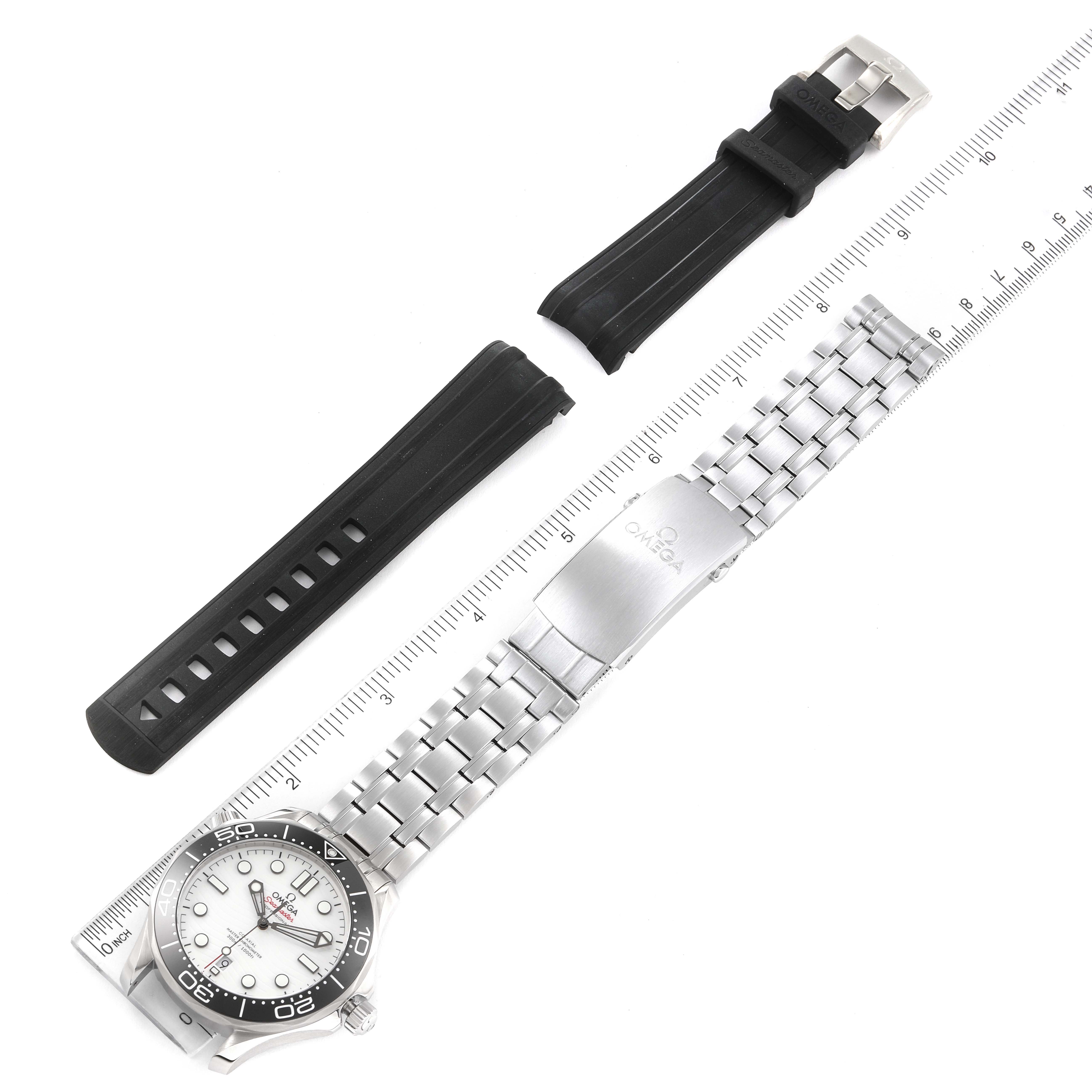 This image shows an Omega Seamaster 210.30.42.20.04.001 Men's Stainless Steel White Dial 210.30.42.20.04.001 Men's Stainless Steel White Dial watch, a metal bracelet, and black rubber straps, displayed alongside a ruler.