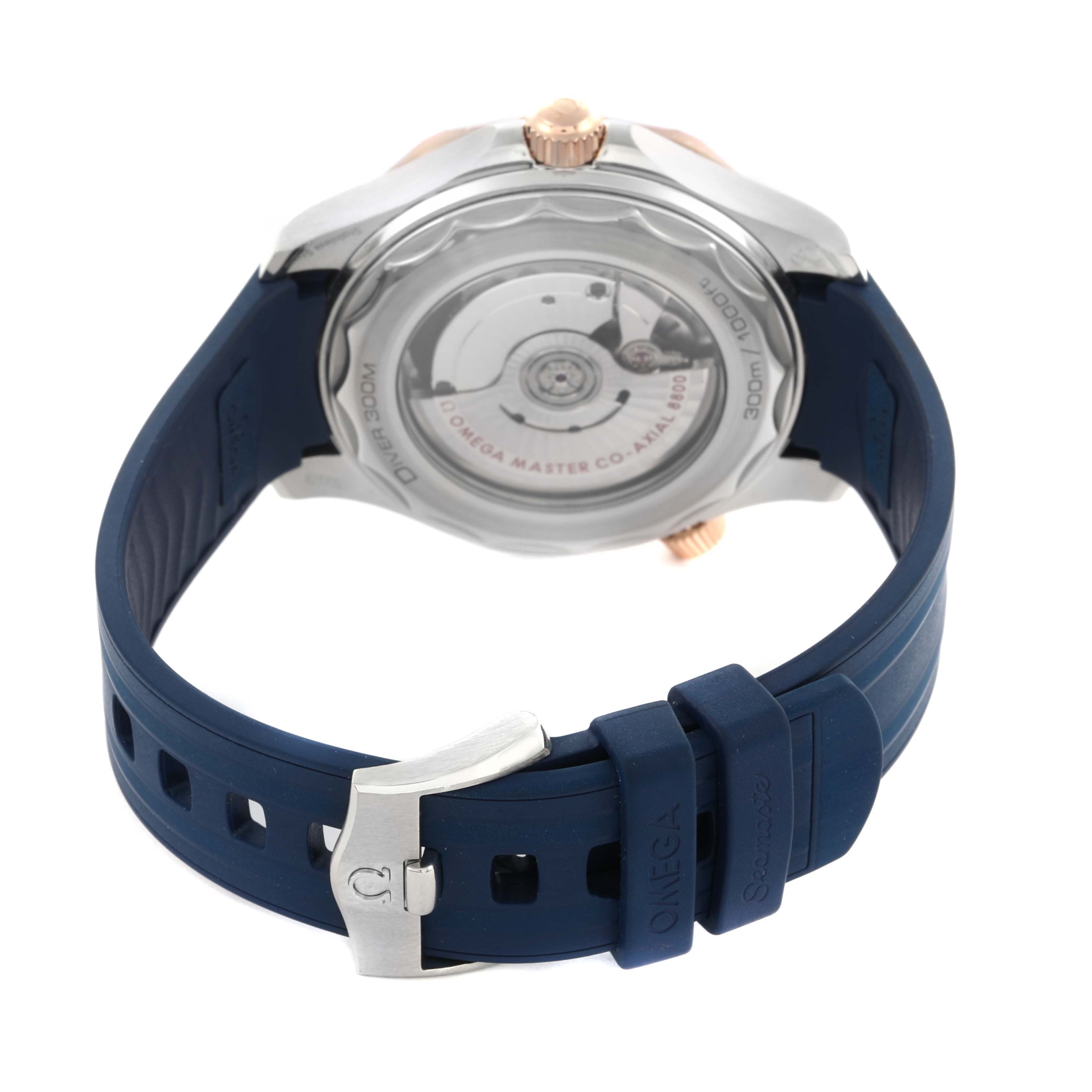 The image shows the back view of the Omega Seamaster 210.22.42.20.03.002 Men's Steel and Gold (two tone) Blue Dial 210.22.42.20.03.002 Men's Steel and Gold (two tone) Blue Dial watch, highlighting its transparent case back and blue rubber strap.