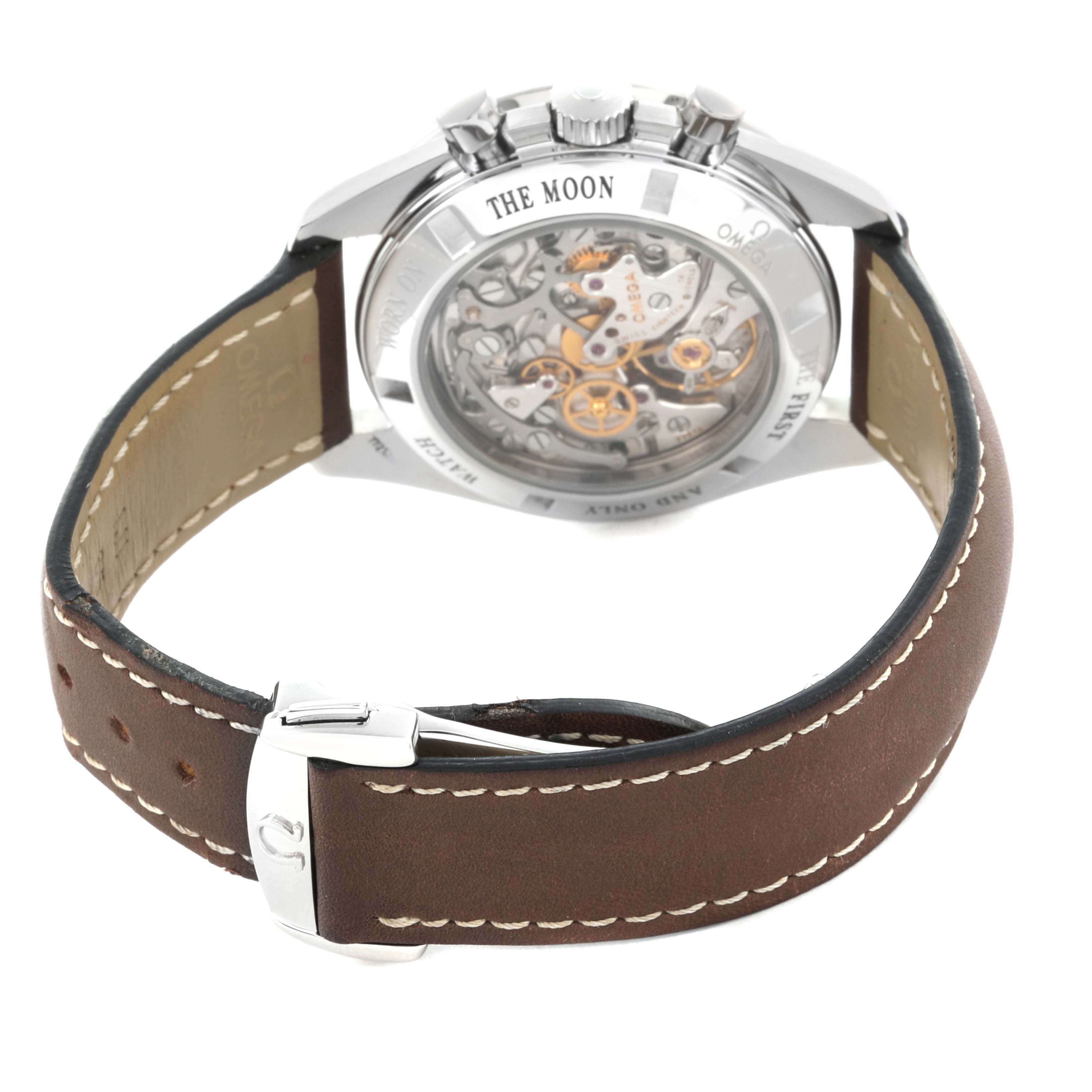 The image shows the Omega Speedmaster 311.30.42.30.13.001 Men's Stainless Steel Brown Dial 311.30.42.30.13.001 Men's Stainless Steel Brown Dial's open back case and movement with a brown leather strap from a rear angle.