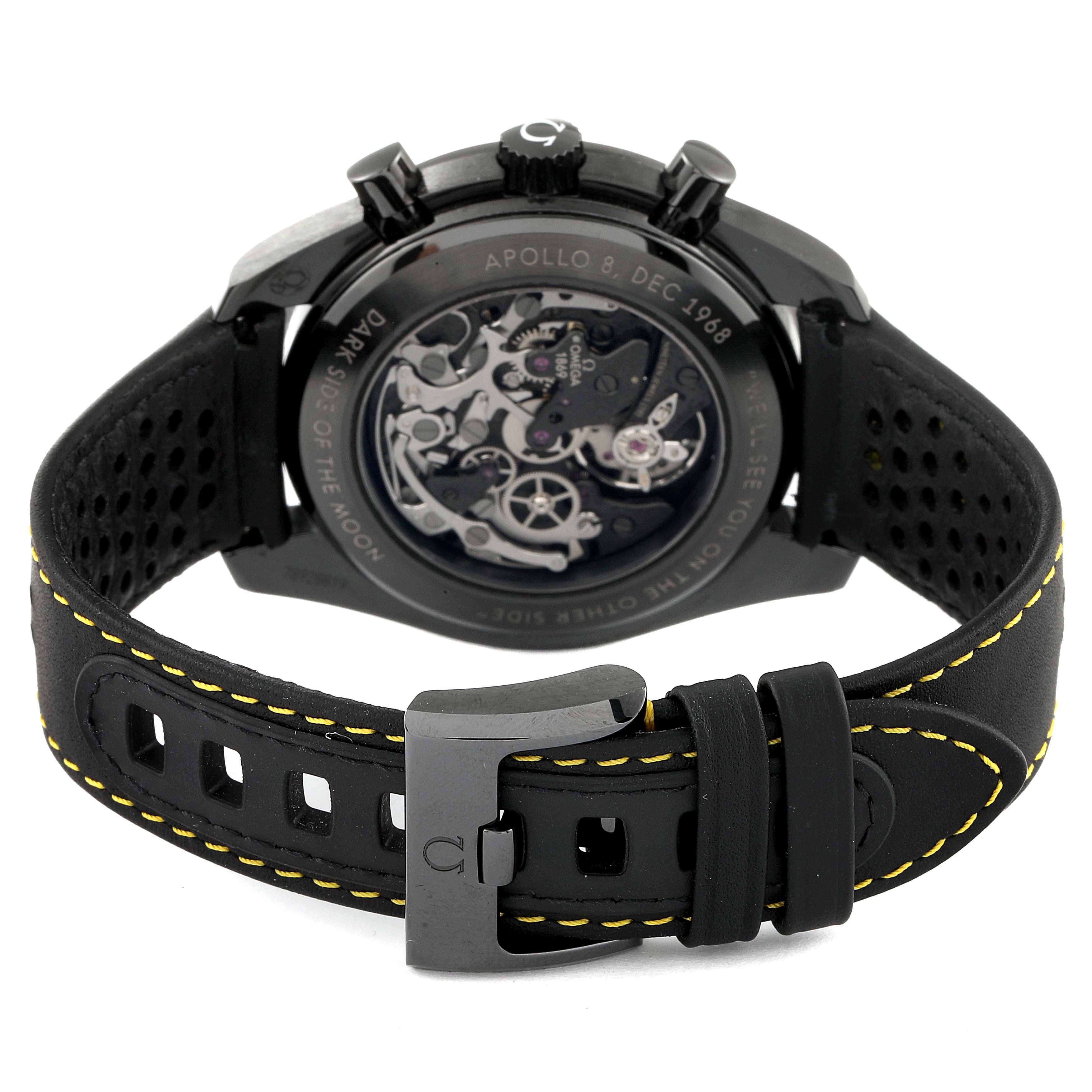 The image shows the back and strap of the Omega Speedmaster 311.92.44.30.01.001 Men's Ceramic Black Dial 311.92.44.30.01.001 Men's Ceramic Black Dial watch, highlighting the transparent case back and black leather strap with yellow stitching.