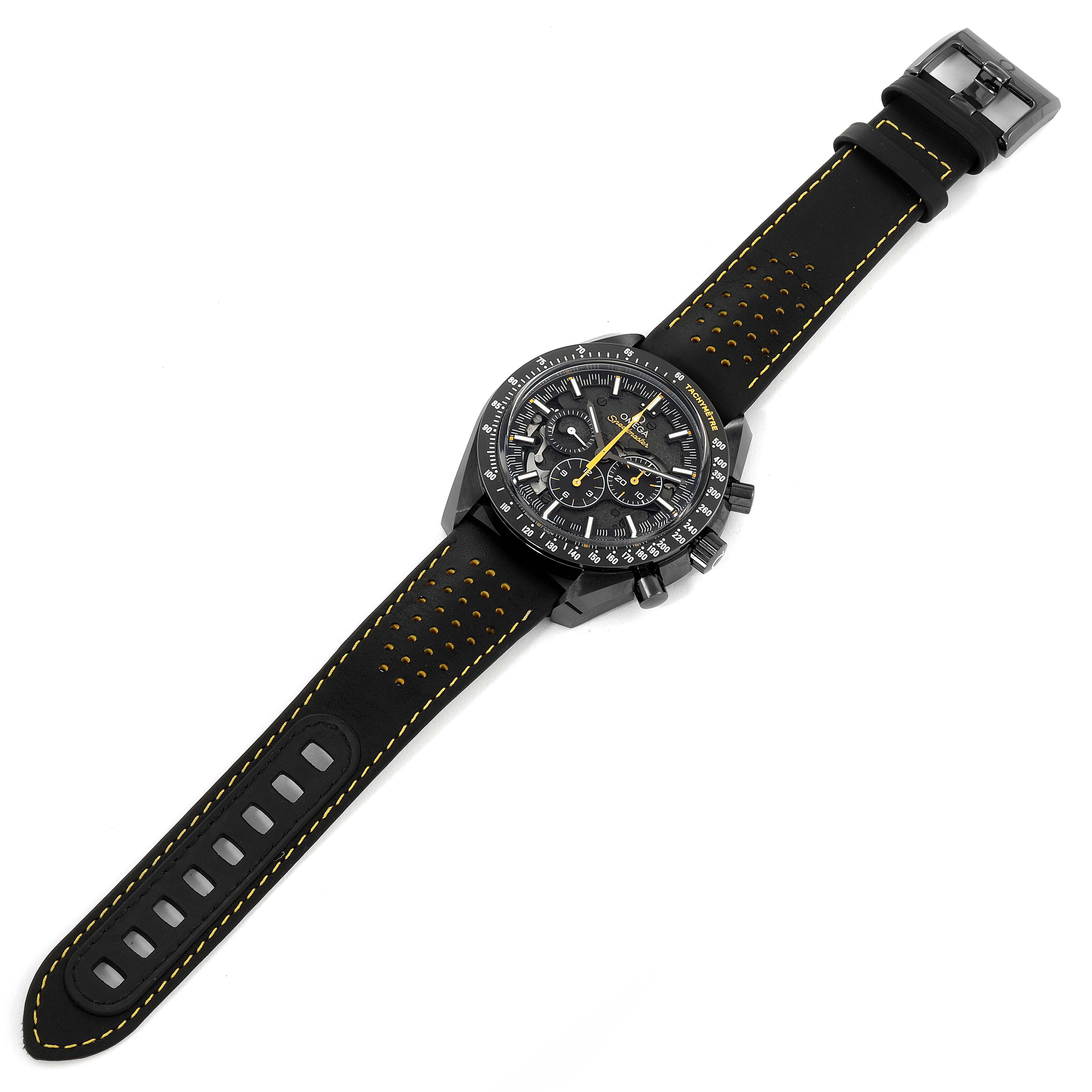 This is an overhead view of an Omega Speedmaster 311.92.44.30.01.001 Men's Ceramic Black Dial 311.92.44.30.01.001 Men's Ceramic Black Dial watch with a black strap featuring yellow stitching.