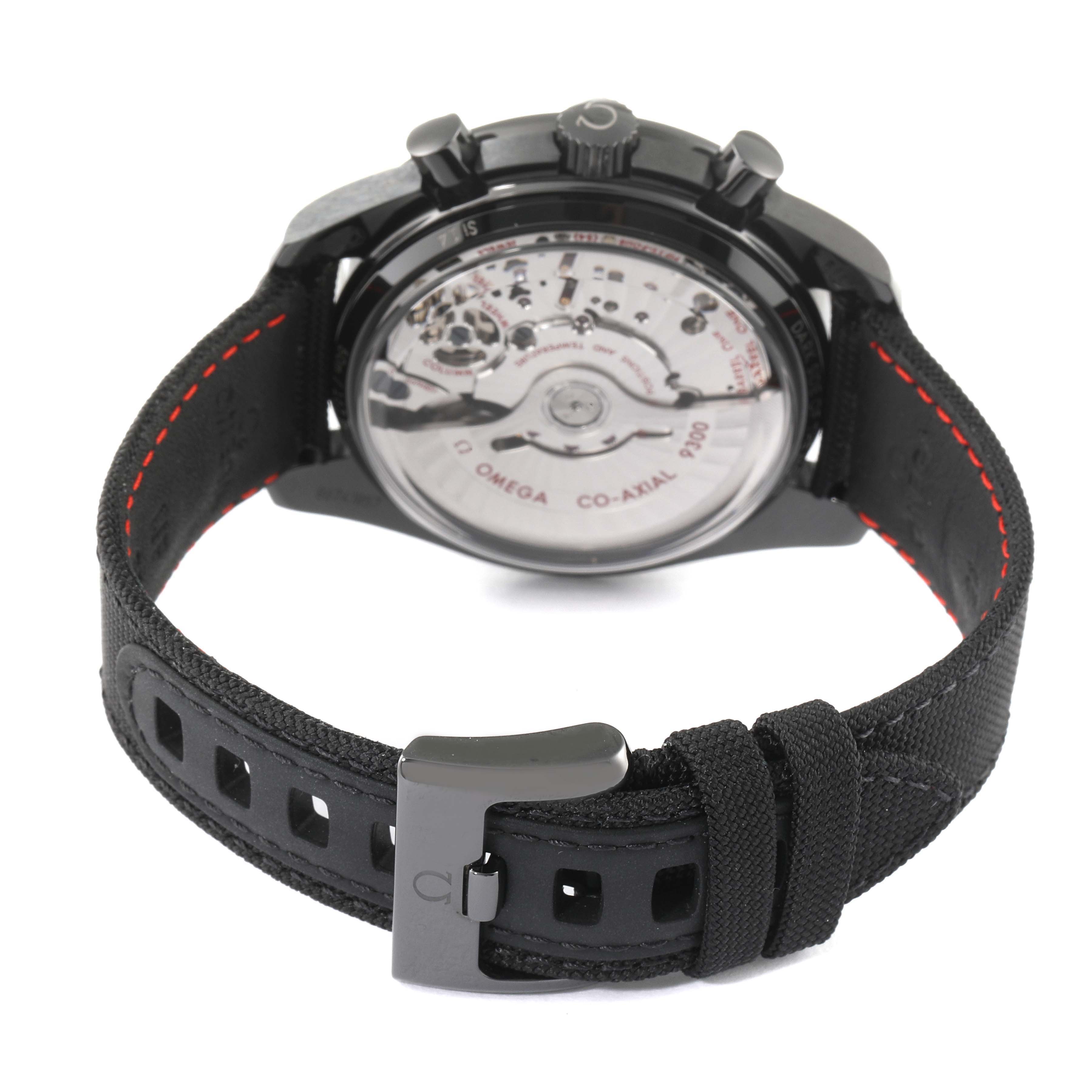 The image shows the back view of the Omega Speedmaster 311.92.44.51.01.003 Men
s Stainless Steel Black Dial 311.92.44.51.01.003 Men
s Stainless Steel Black Dial watch, including its movement and black strap with red stitching.