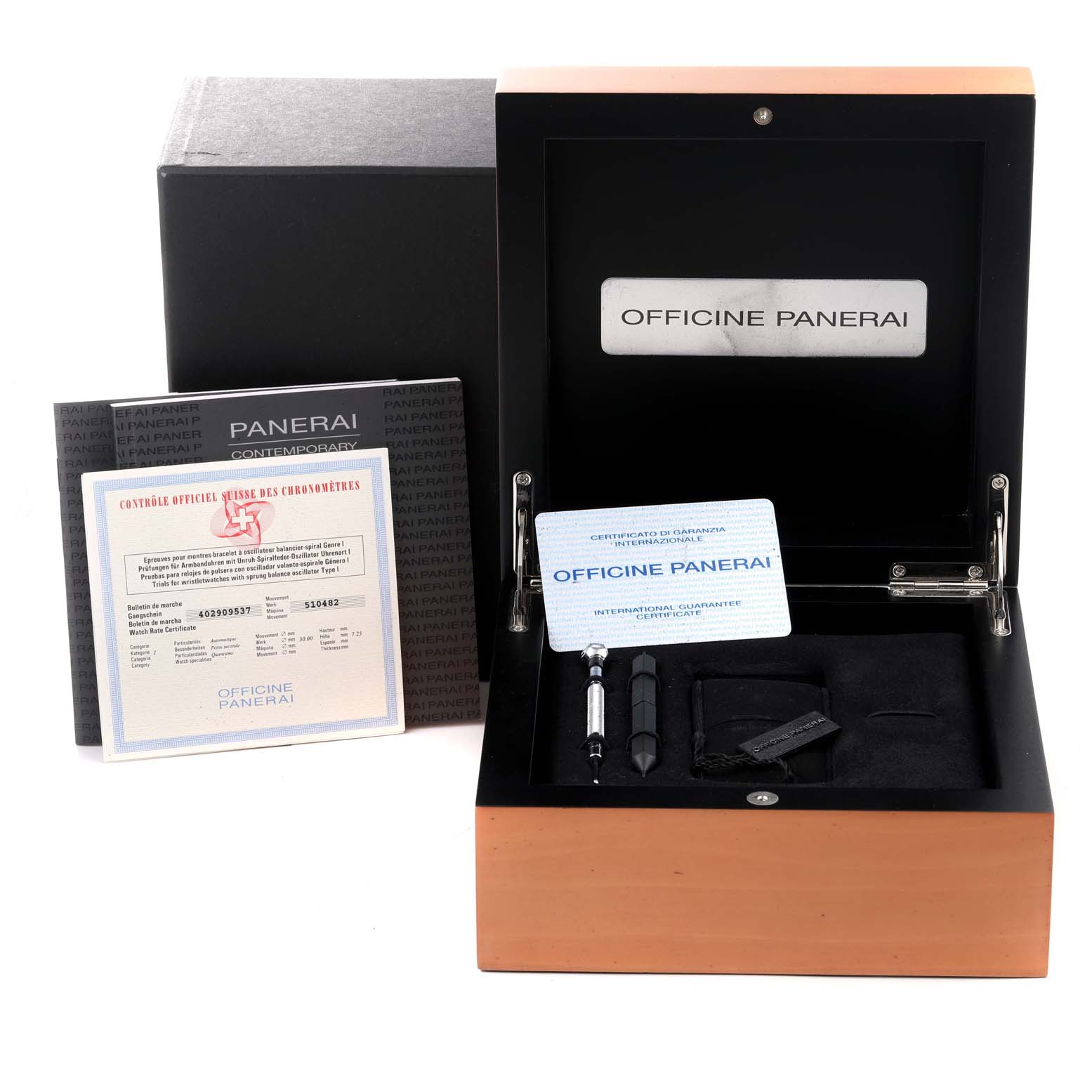 The image shows a Panerai Luminor PAM00104 Men
s Stainless Steel Black Dial PAM00104 Men
s Stainless Steel Black Dial watch box with documents, tools, and accessories.