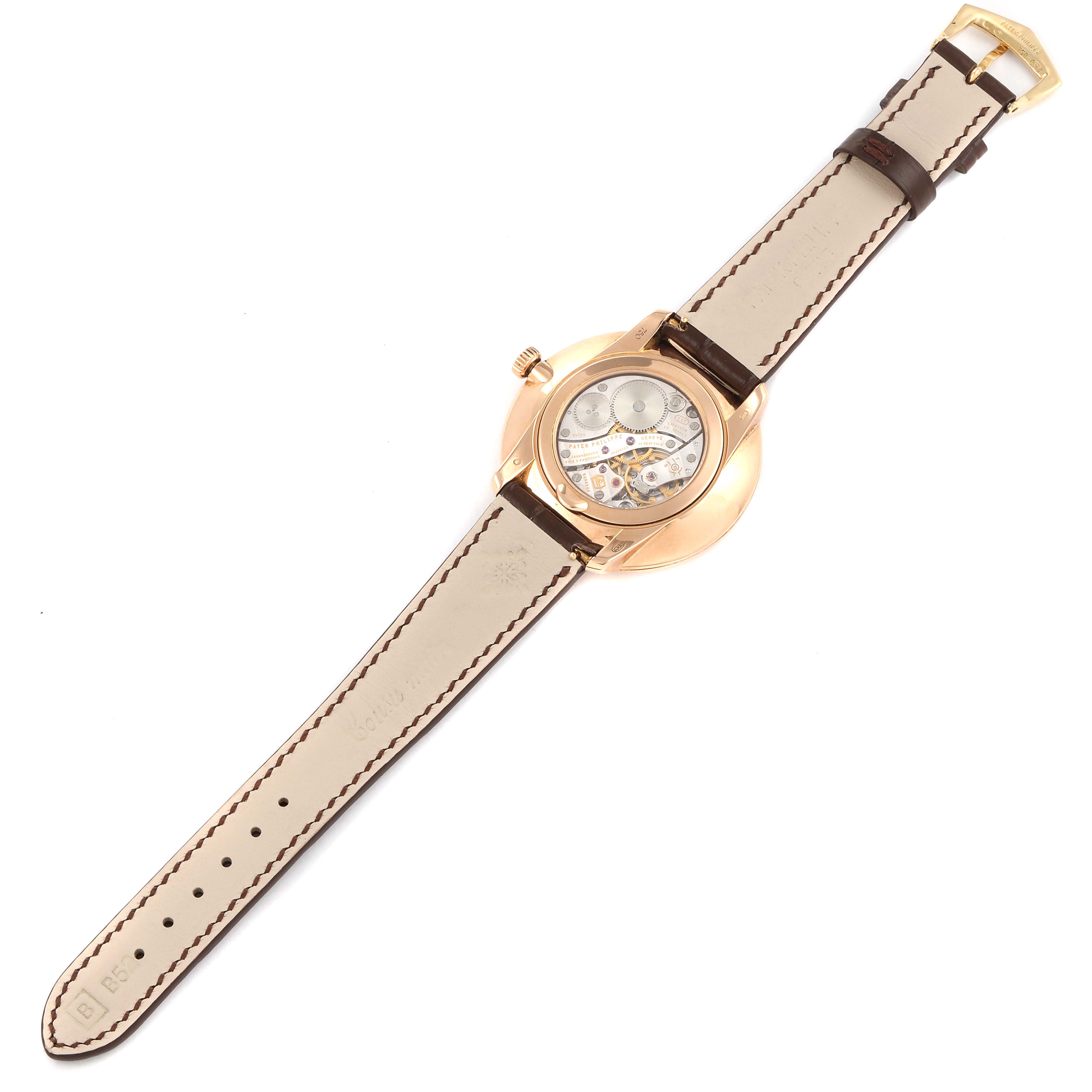 The Patek Philippe Calatrava 5123R-001 Men's Rose Gold Silver Dial 5123R-001 Men's Rose Gold Silver Dial watch is shown from the back, revealing the movement and leather strap.