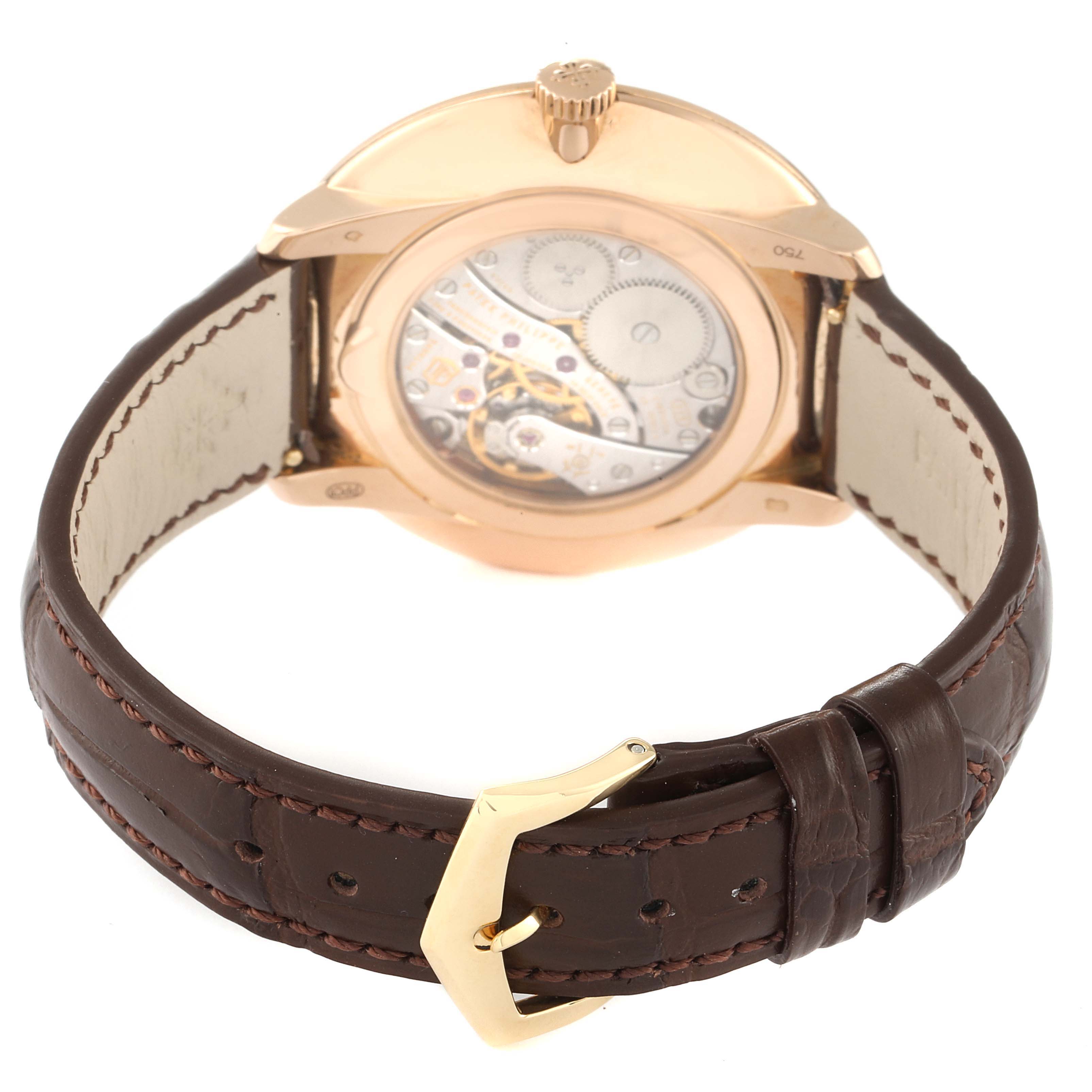 This image shows the back view of a Patek Philippe Calatrava 5123R-001 Men's Rose Gold Silver Dial 5123R-001 Men's Rose Gold Silver Dial watch, highlighting its movement and leather strap.