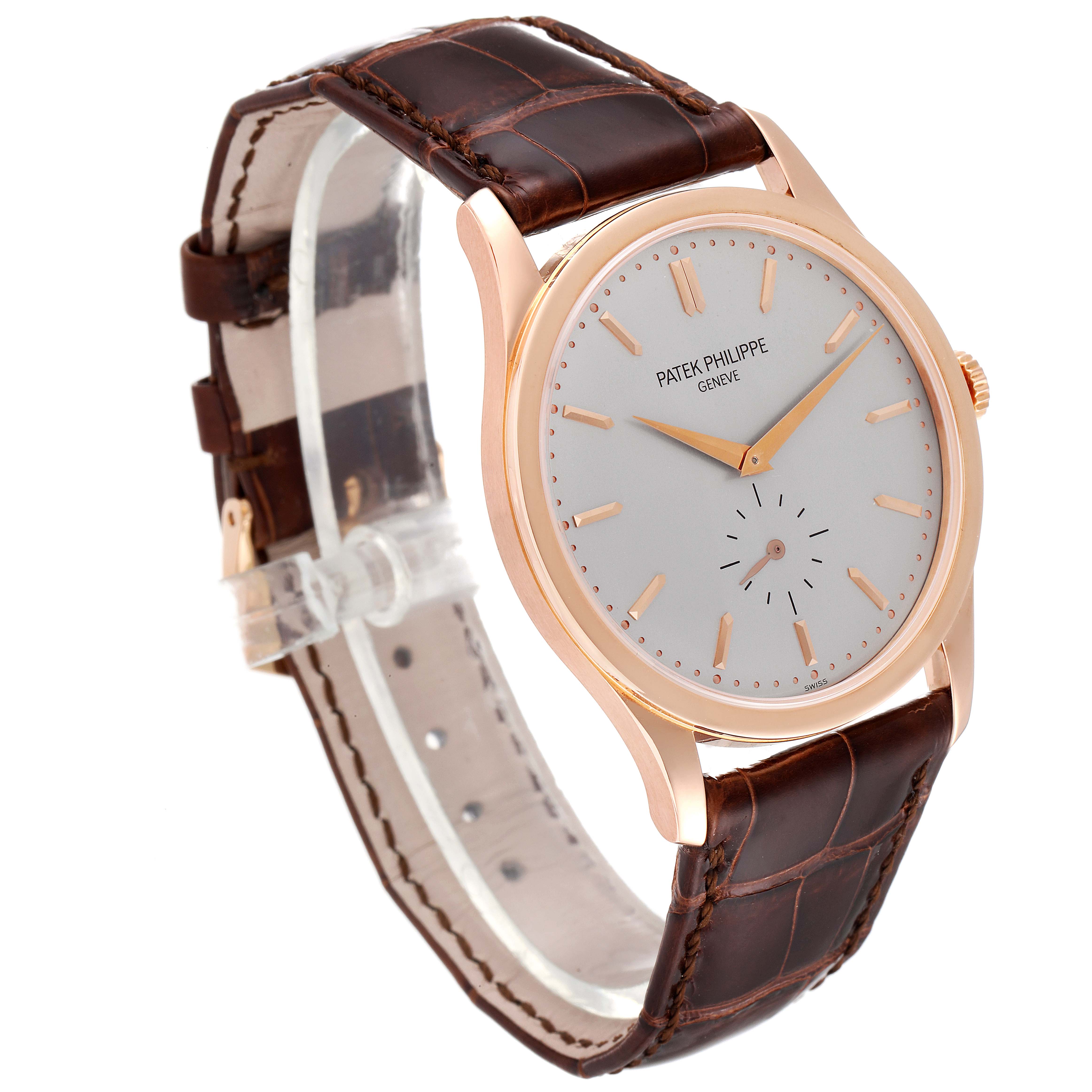 This image shows a Patek Philippe Calatrava 5196R Men's Rose Gold Silver Dial 5196R Men's Rose Gold Silver Dial watch from a front-side angle, highlighting its dial, case, and leather strap.