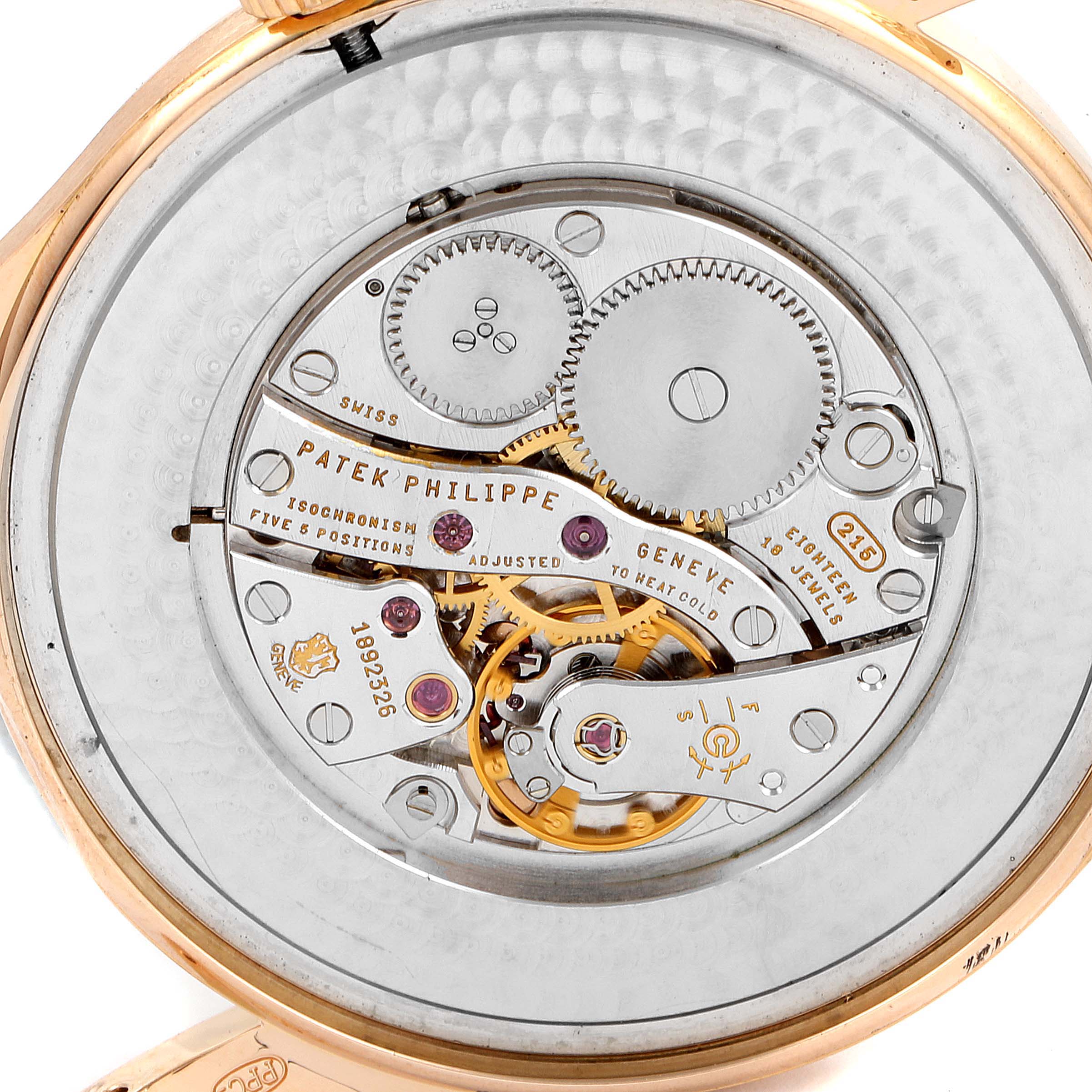 The image shows the movement and intricate inner workings of a Patek Philippe Calatrava 5196R Men's Rose Gold Silver Dial 5196R Men's Rose Gold Silver Dial watch.