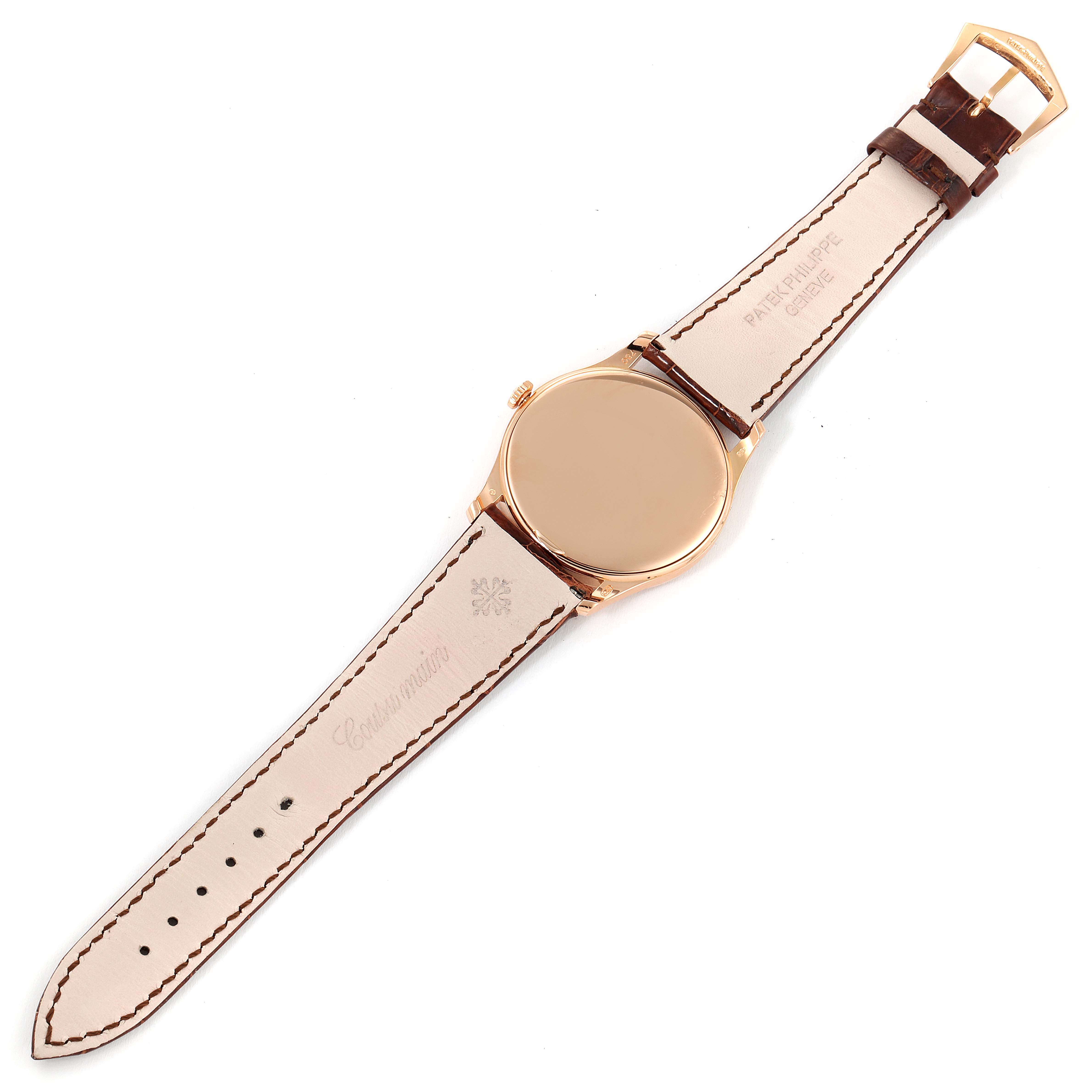 The Patek Philippe Calatrava 5196R Men's Rose Gold Silver Dial 5196R Men's Rose Gold Silver Dial watch is shown from the back, displaying its leather strap, buckle, and caseback.