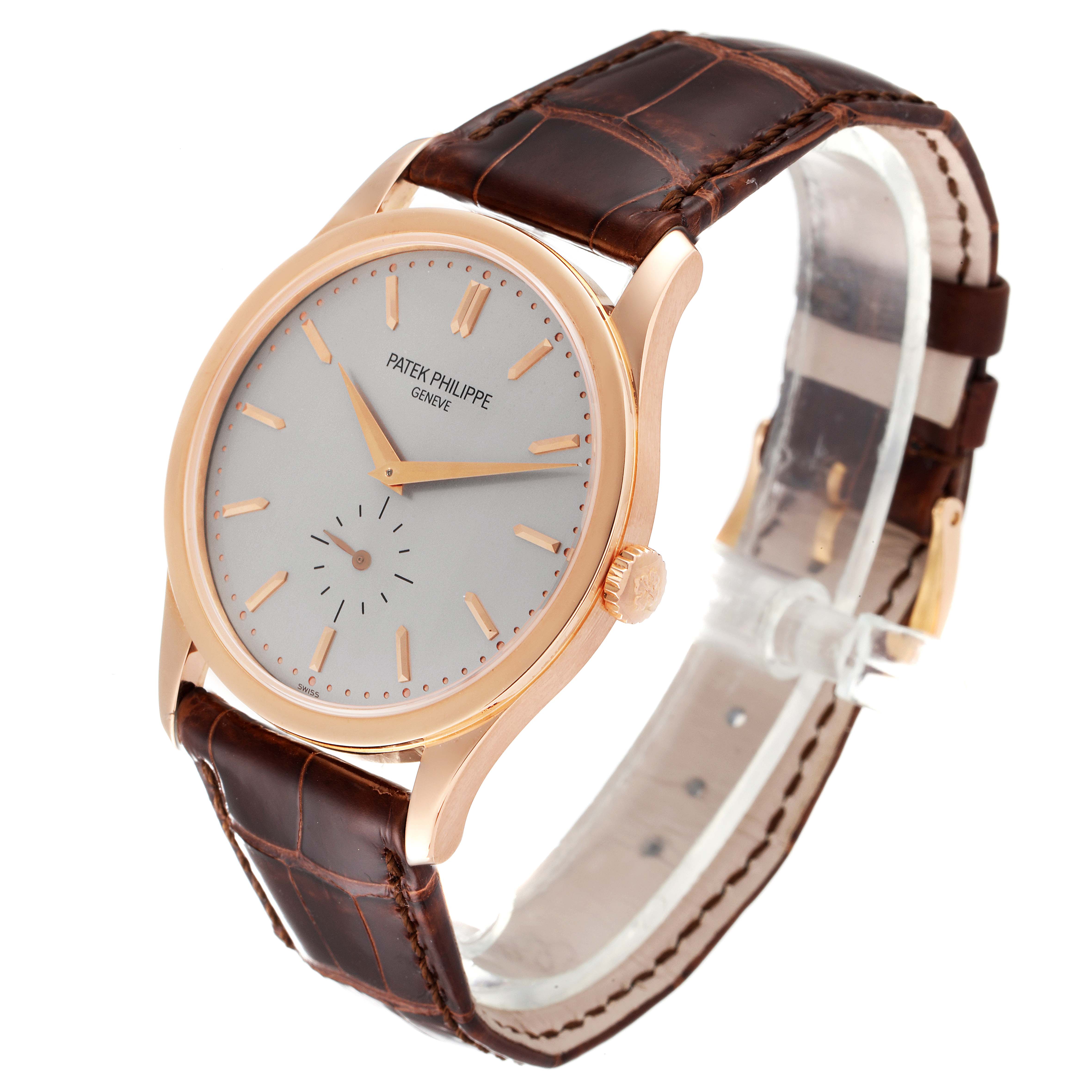 This is a Patek Philippe Calatrava 5196R Men's Rose Gold Silver Dial 5196R Men's Rose Gold Silver Dial watch, shown at an angle displaying its dial, crown, case, and leather strap.