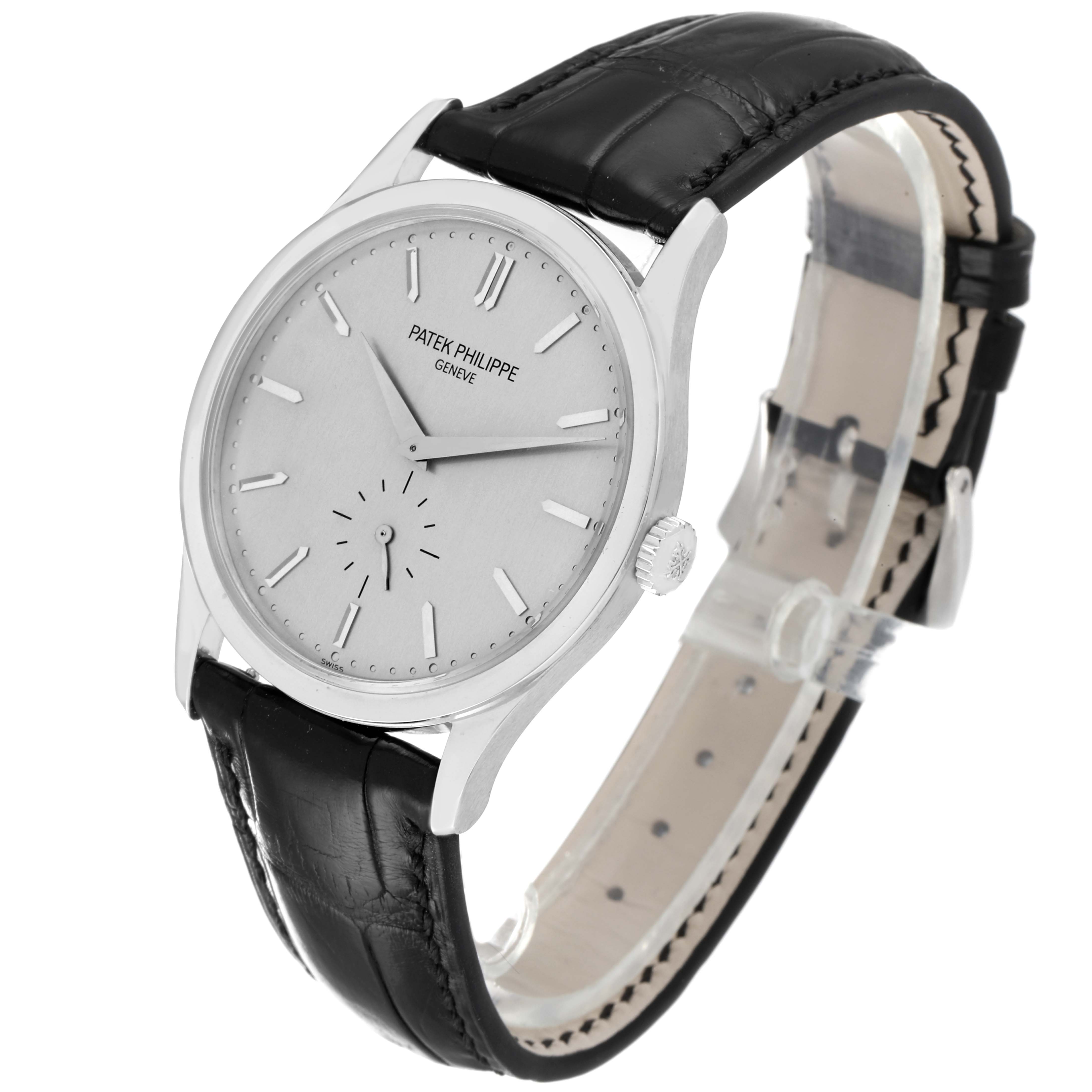 The image shows a side angle of the Patek Philippe Calatrava 5196G Men's White Gold Silver Dial 5196G Men's White Gold Silver Dial watch, highlighting its face, crown, and black leather strap.