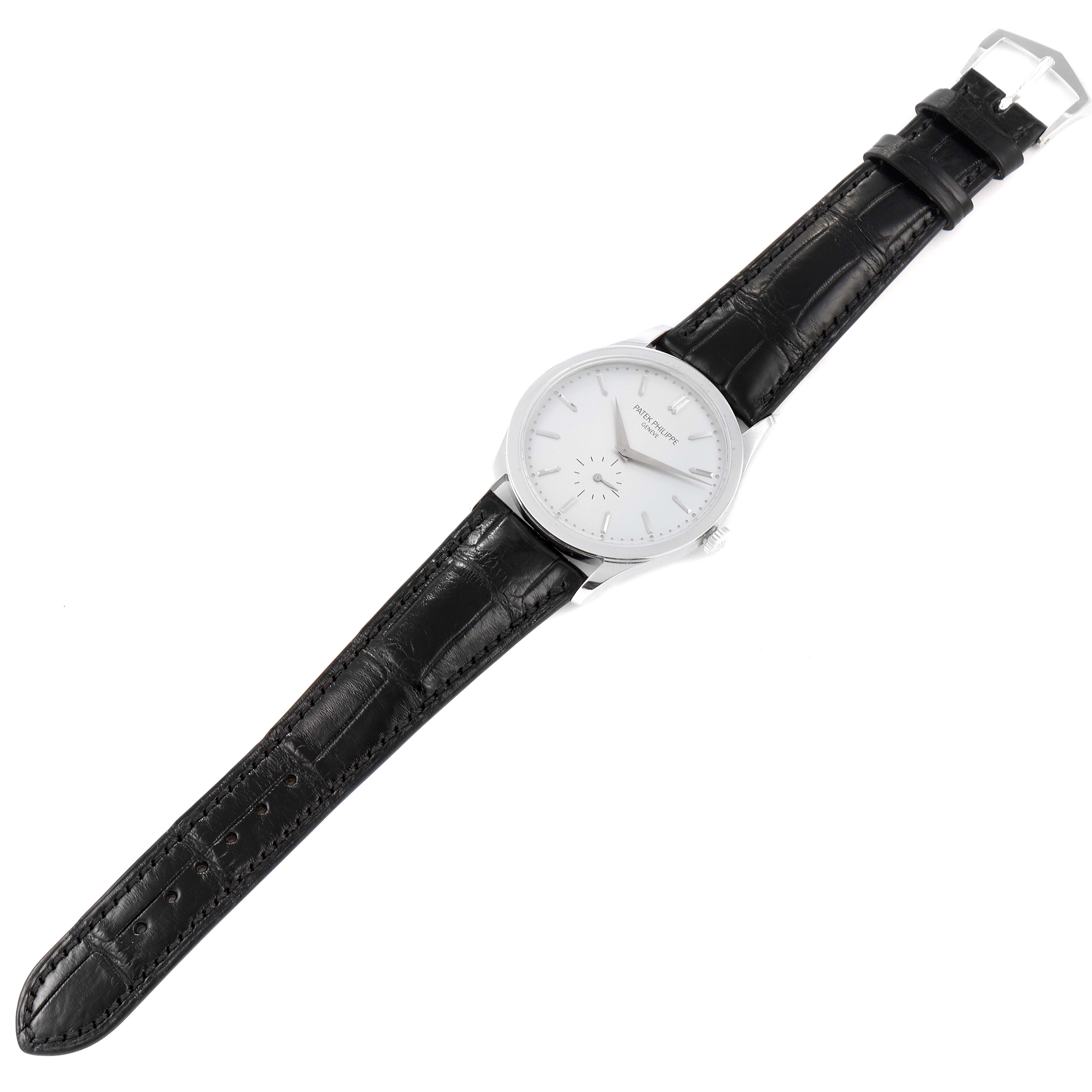 The image shows a top view of the Patek Philippe Calatrava 5196G Men's White Gold Silver Dial 5196G Men's White Gold Silver Dial watch, displaying its dial, case, and black leather strap.