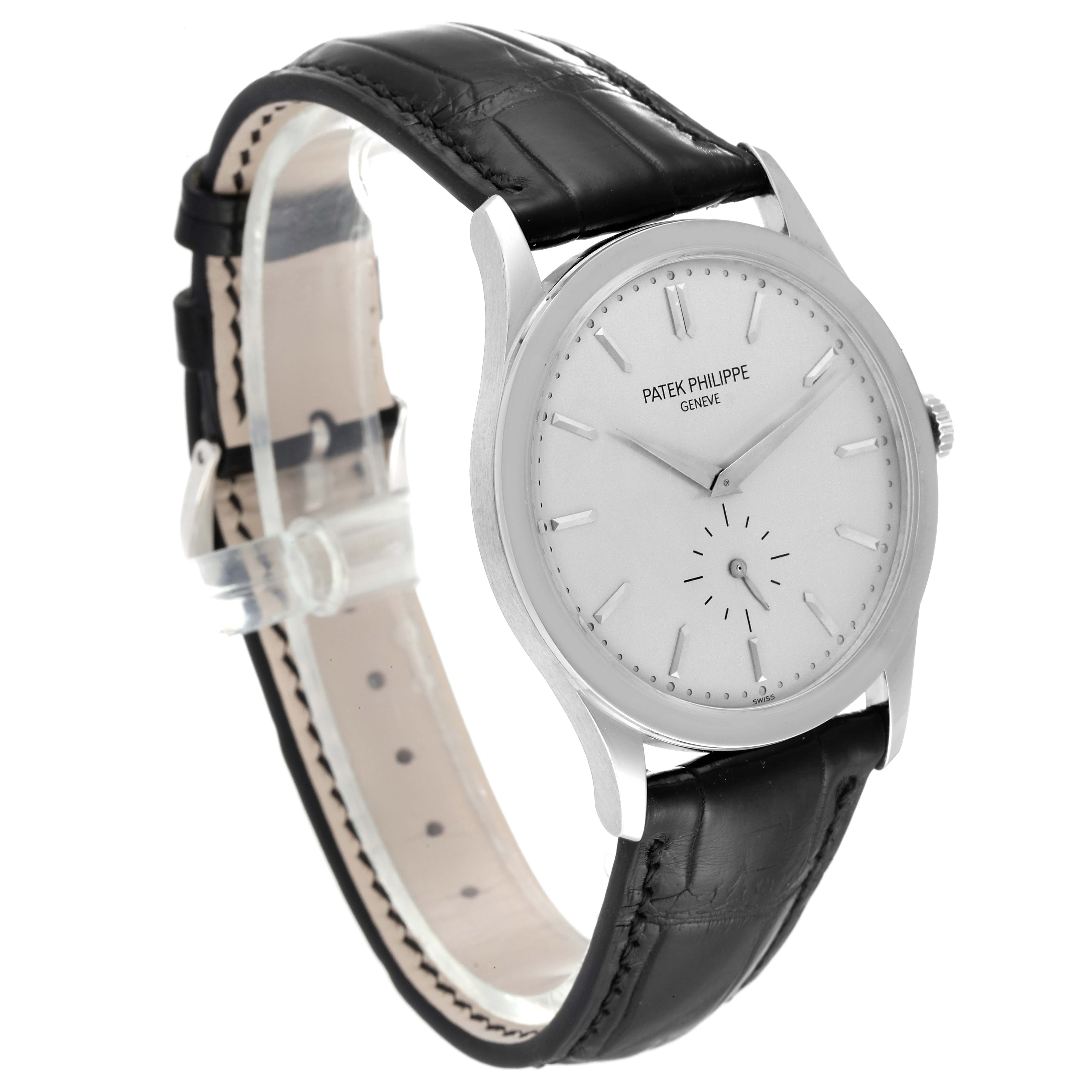 The image shows a side angle of a Patek Philippe Calatrava 5196G Men's White Gold Silver Dial 5196G Men's White Gold Silver Dial watch with a black leather strap and white dial.