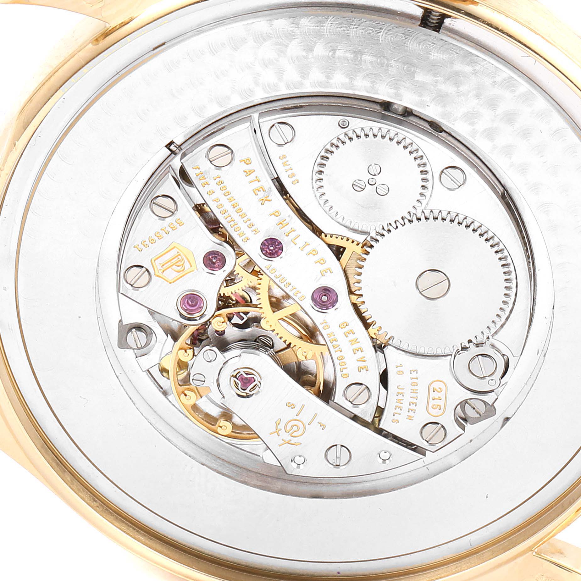 The image shows the intricate movement and gears of the Patek Philippe Calatrava 5196J Men's Yellow Gold Silver Dial 5196J Men's Yellow Gold Silver Dial watch from the back angle.