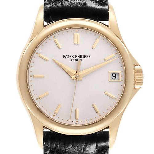 The Patek Philippe Calatrava watch is shown from the front, displaying its face, hands, crown, and part of the strap.